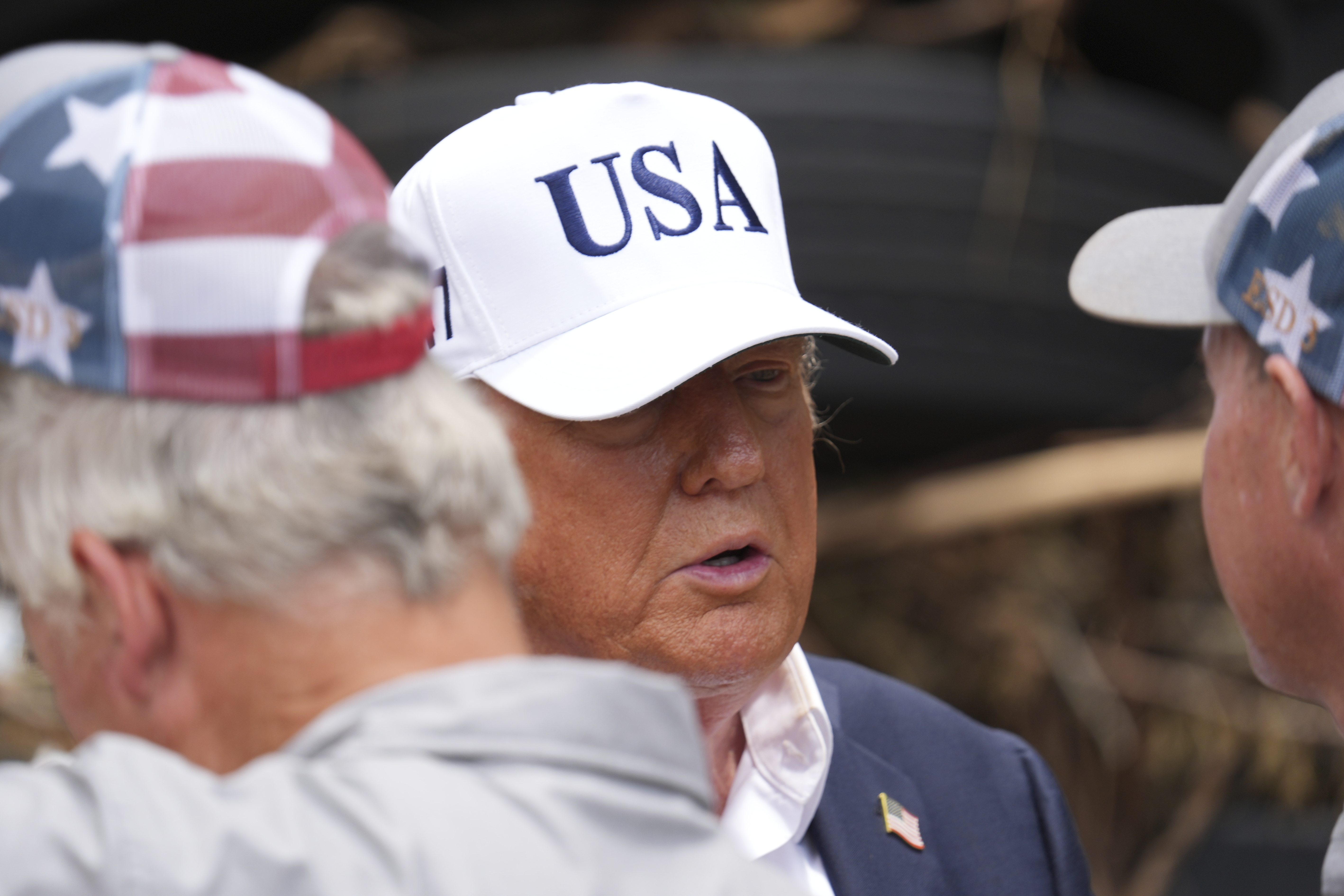 President Donald Trump, center, greets first responders as he observes flood damage in Kerrville, Texas, Friday, July 11, 2025. (AP Photo/Jacquelyn Martin)