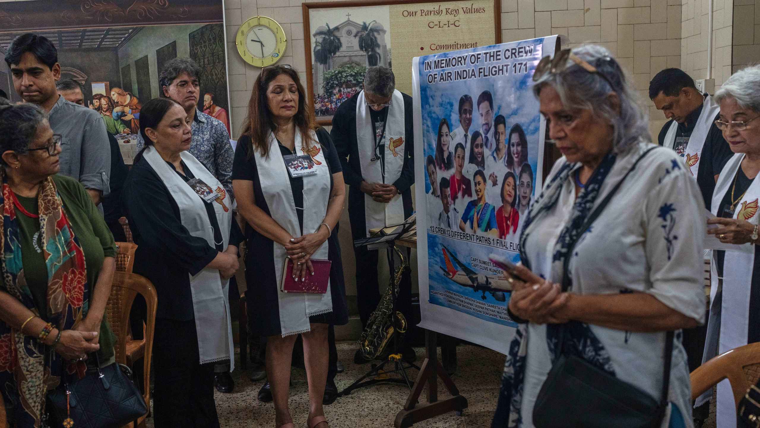 People offer prayers for crew members of the Air India flight that crashed in Ahmedabad last month during a prayer meeting at a church in Mumbai, India, Saturday, July 12, 2025. (AP Photo/ Rafiq Maqbool)