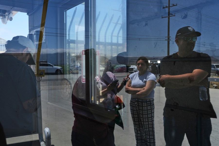 People wait outside of Glass House Farms, a day after an immigration raid on the facility, Friday, July 11, 2025, in Camarillo, Calif. (AP Photo/Jae C. Hong)