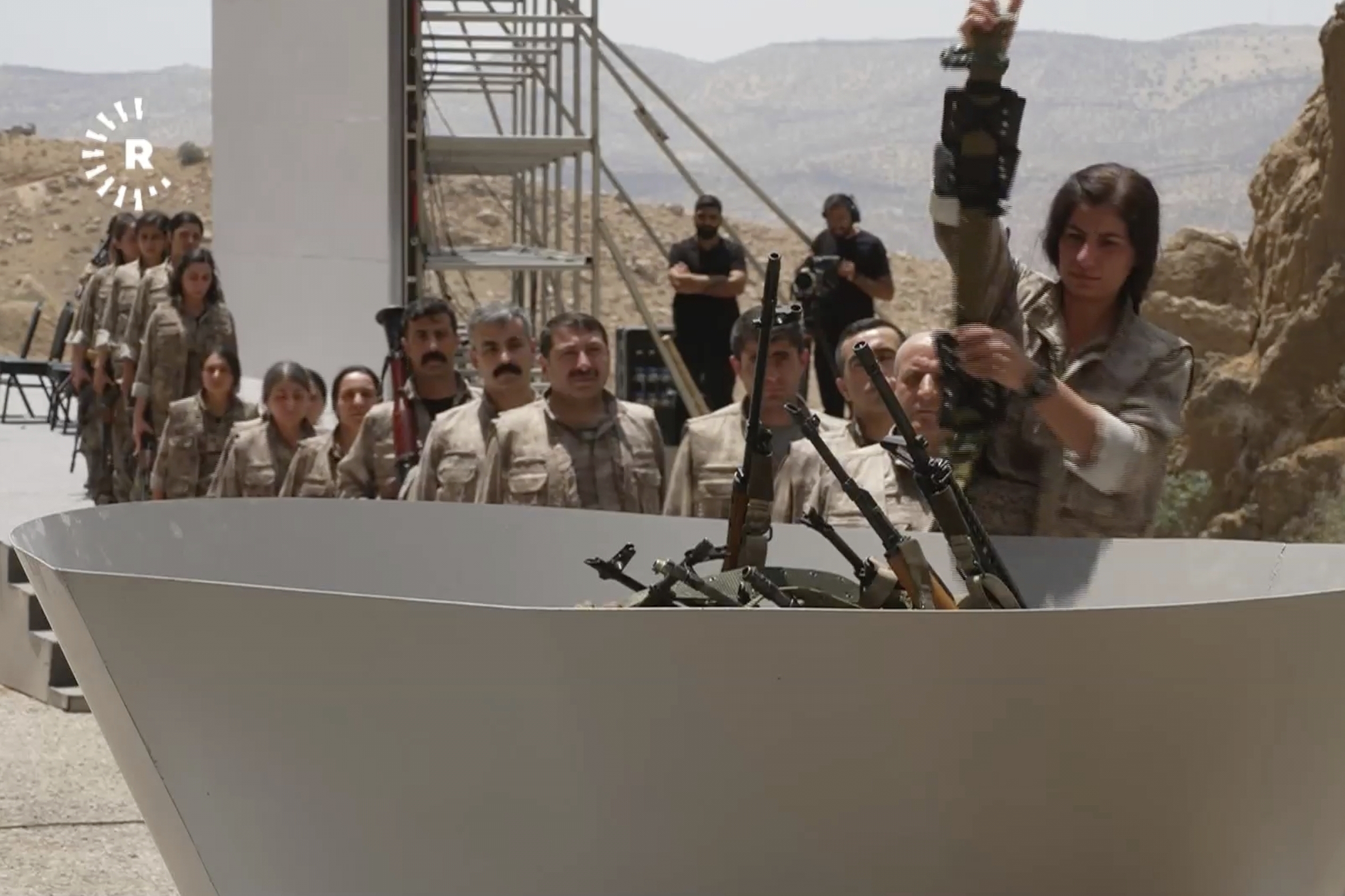 This frame grab from a video released by Rudy TV shows PPK (Kurdistan Workers' Party) fighters during a symbolic disarmament ceremony as part of the peace process with Turkey, in Sulaymaniyah governorate, in Iraq's semi-autonomous Kurdish region, Friday, July 11, 2025. (Rudaw TV via AP)