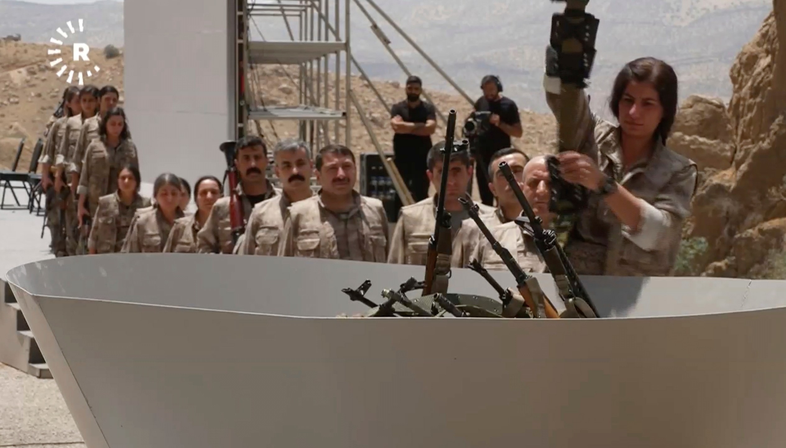 This frame grab from a video released by Rudy TV shows PPK (Kurdistan Workers' Party) fighters during a symbolic disarmament ceremony as part of the peace process with Turkey, in Sulaymaniyah governorate, in Iraq's semi-autonomous Kurdish region, Friday, July 11, 2025. (Rudaw TV via AP)