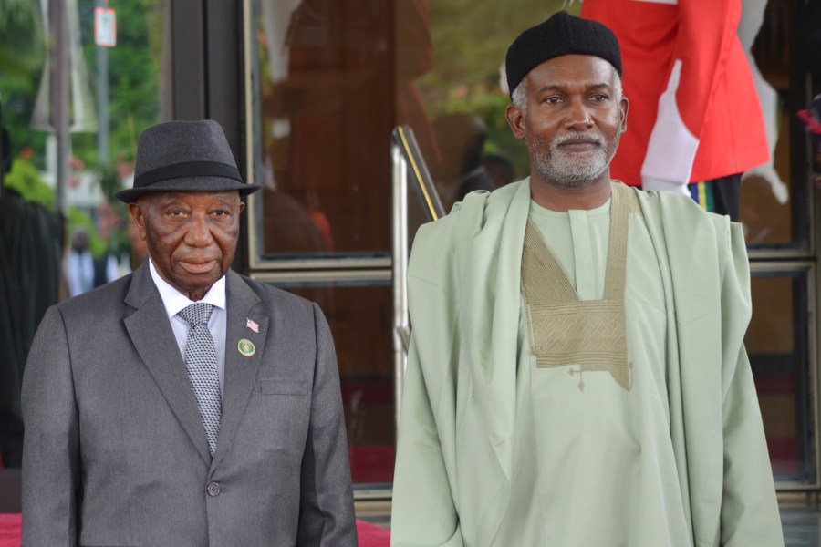 FILE - Liberia's President, Joseph Boakai, left, and Nigeria Minister of Foreign Affairs, Yusuf Tuggar, right, pose for a photo, prior to the start of the ECOWAS meeting, in Abuja, Nigeria, July 7, 2024. (AP Photo/Olamikan Gbemiga, File)
