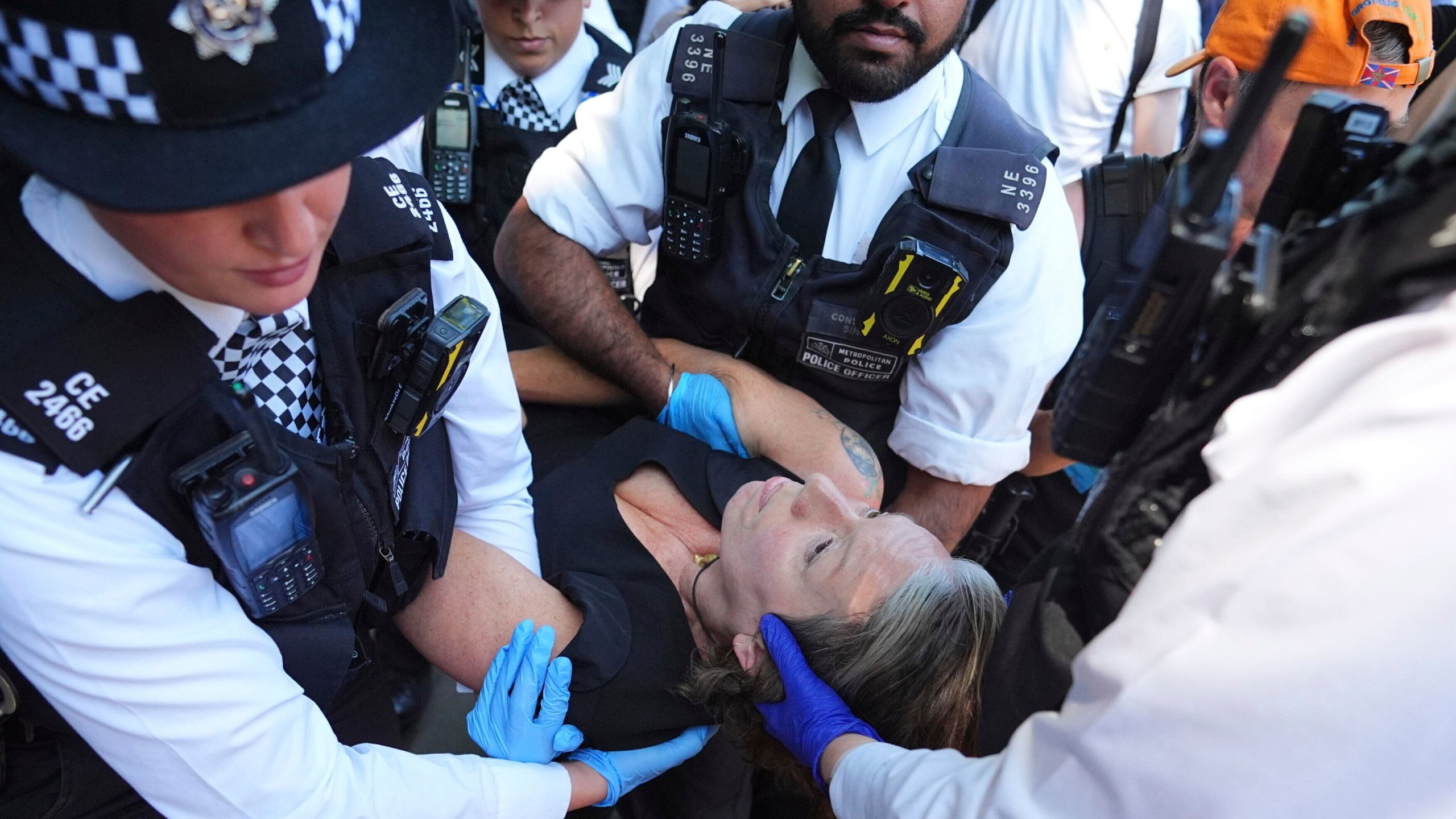 Police officers remove a person after they took part in a protest in Parliament Square, to call for de-proscription of 'Palestine Action' after a ban against the organisation was announced, in London, Saturday July 12, 2025. (James Manning/PA via AP)