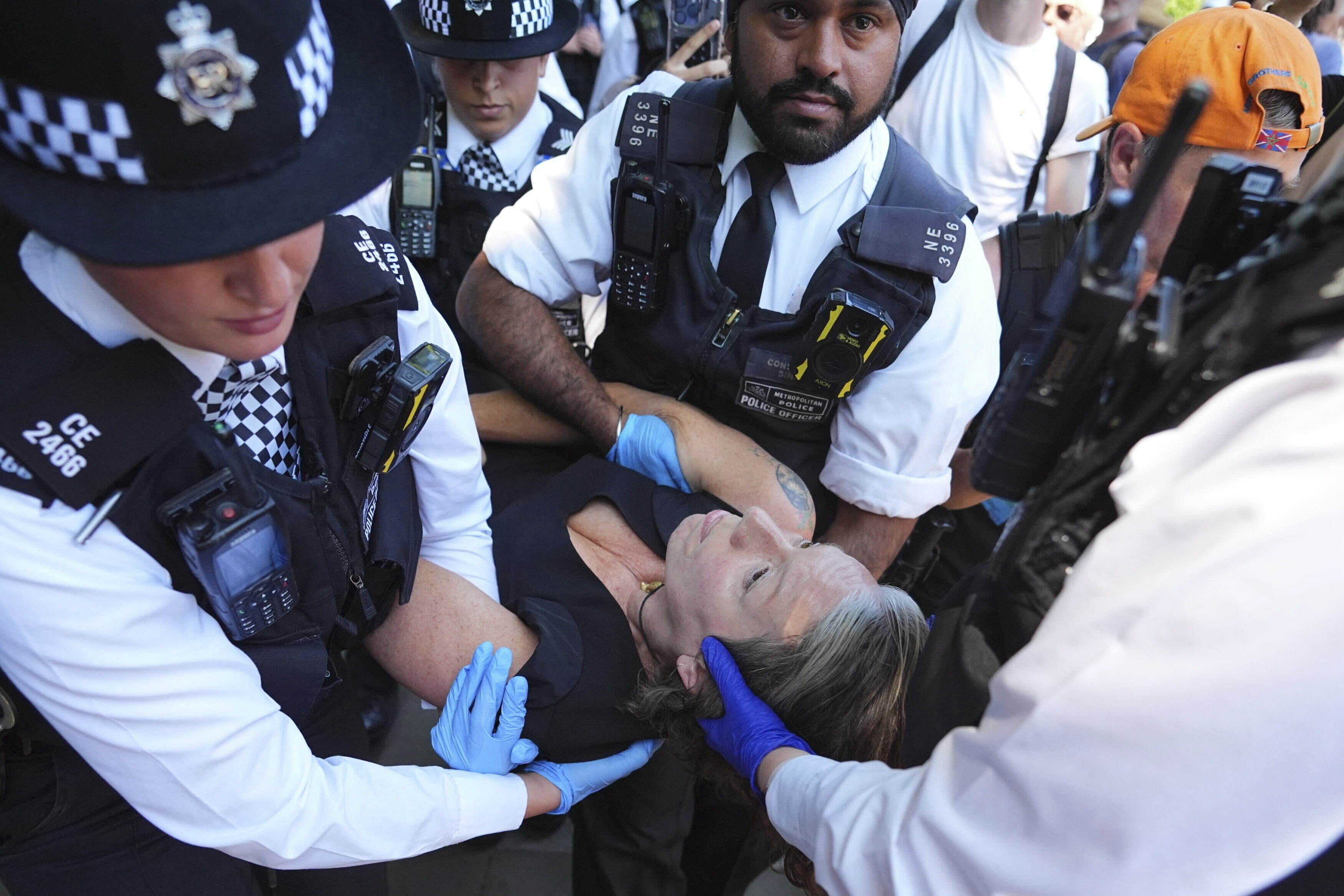 Police officers remove a person after they took part in a protest in Parliament Square, to call for de-proscription of 'Palestine Action' after a ban against the organisation was announced, in London, Saturday July 12, 2025. (James Manning/PA via AP)
