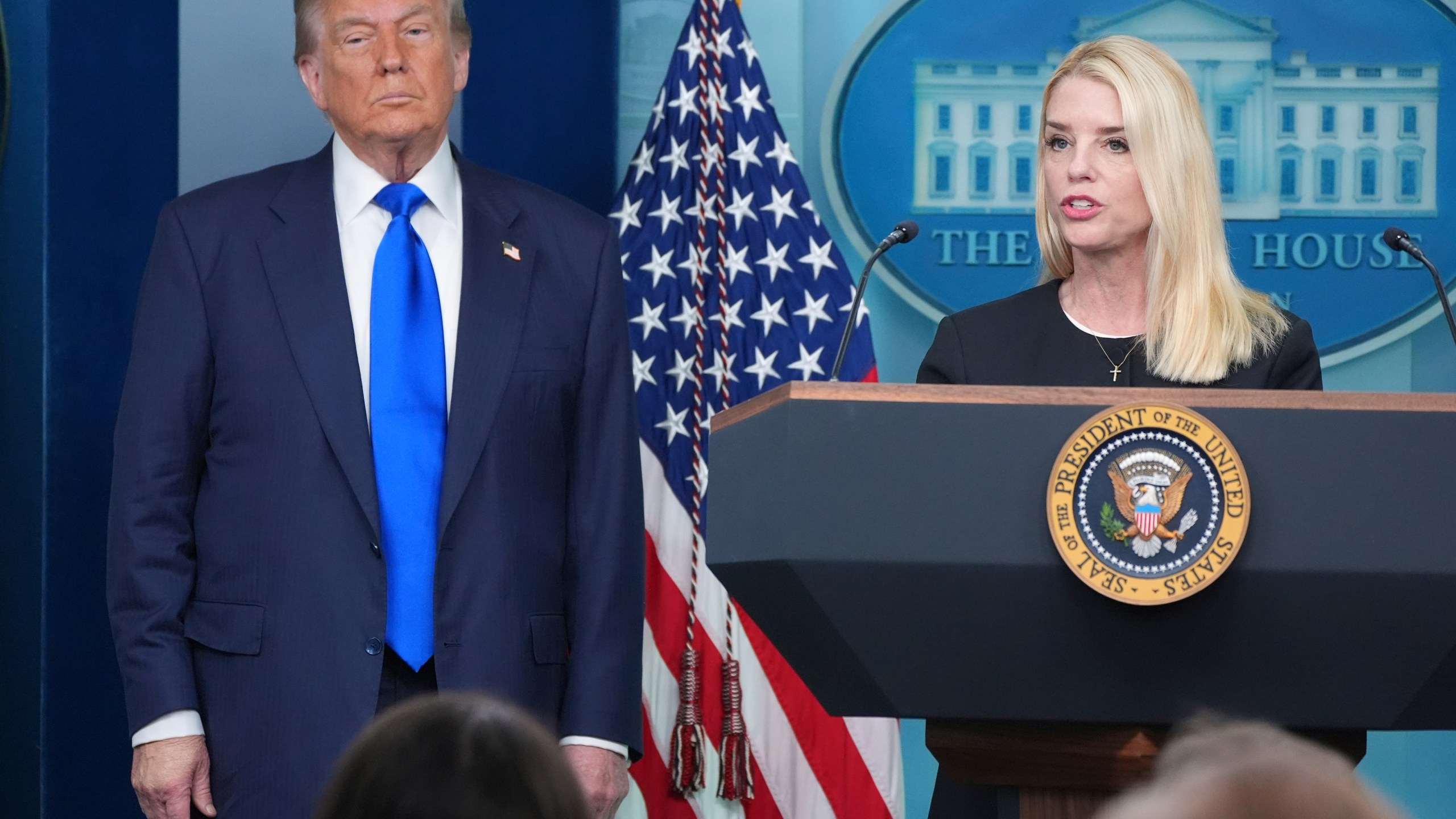 Attorney General Pam Bondi speaks to reporters as President Donald Trump listens, Friday, June 27, 2025, in the briefing room of the White House in Washington. (AP Photo/Jacquelyn Martin)