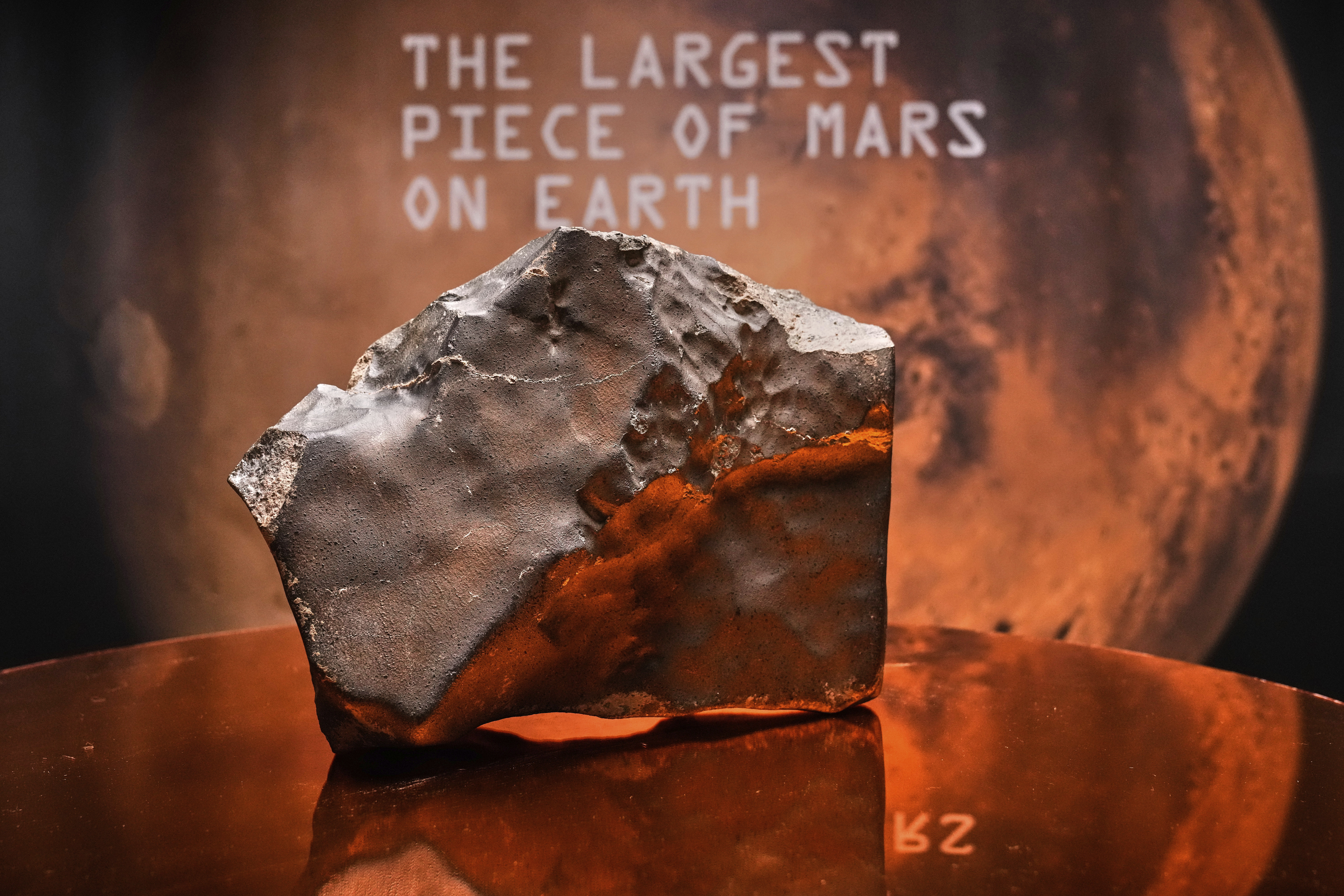 A Martian meteorite, weighing 54.388 lbs. (24.67 kg), said to be the largest piece of Mars on Earth, estimated at $2 - 4 million, is displayed at Sotheby's, in New York, Wednesday, July 9, 2025, part of their Geek Week auction, July 16, 2025. (AP Photo/Richard Drew)