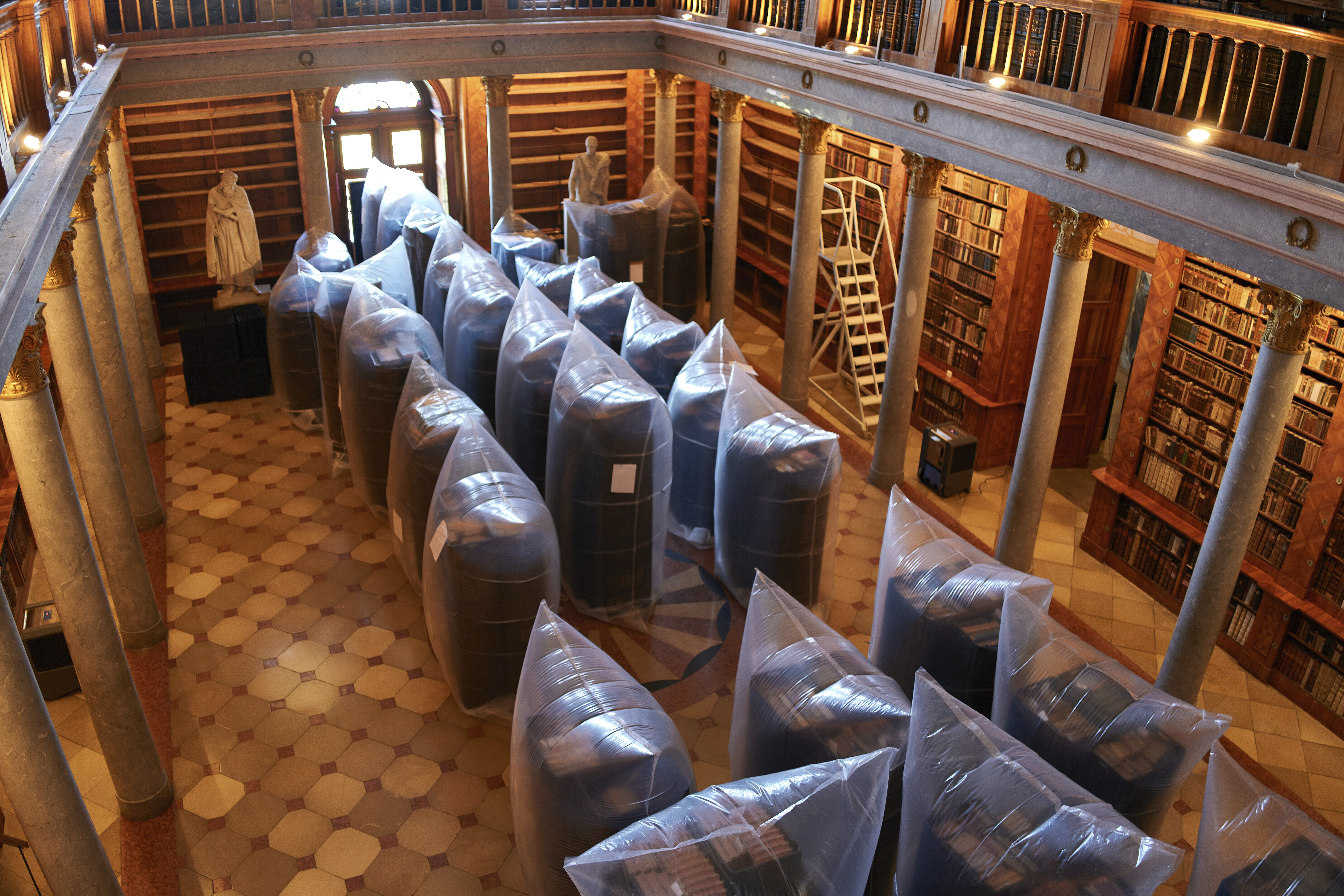 Books are kept in hermetically sealed plastic sacks for disinfection, at the Pannonhalma Archabbey's library in Pannonhalma, Hungary, Thursday, July 3, 2025, as a beetle infestation threatens its ancient collection. (AP Photo/Bela Szandelszky)