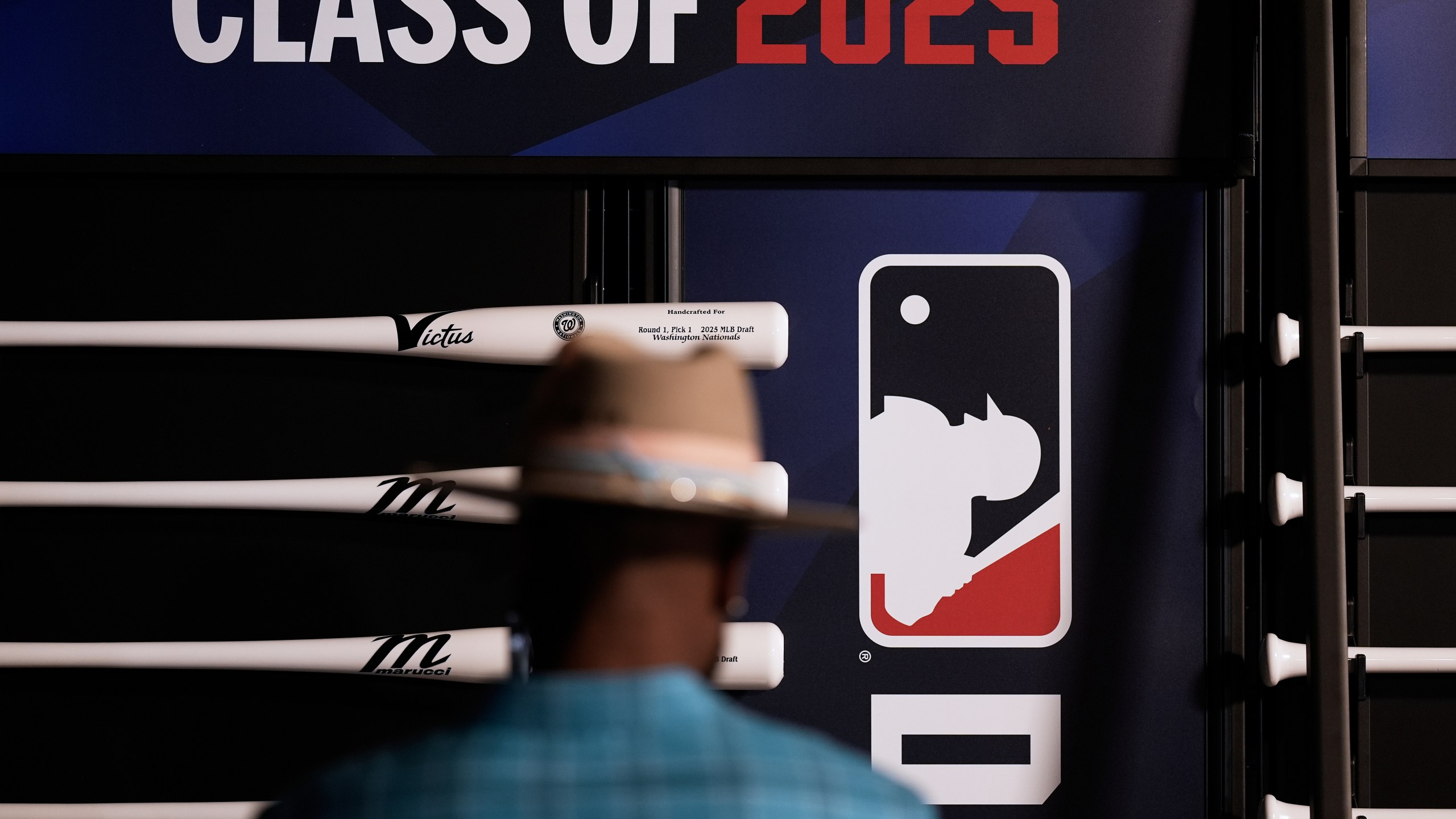 Xavier Scruggs, former professional MLB player looks at specialized bats before the first round of the MLB baseball draft Sunday, July, 13, 2025 in Atlanta. (AP Photo/Mike Stewart)