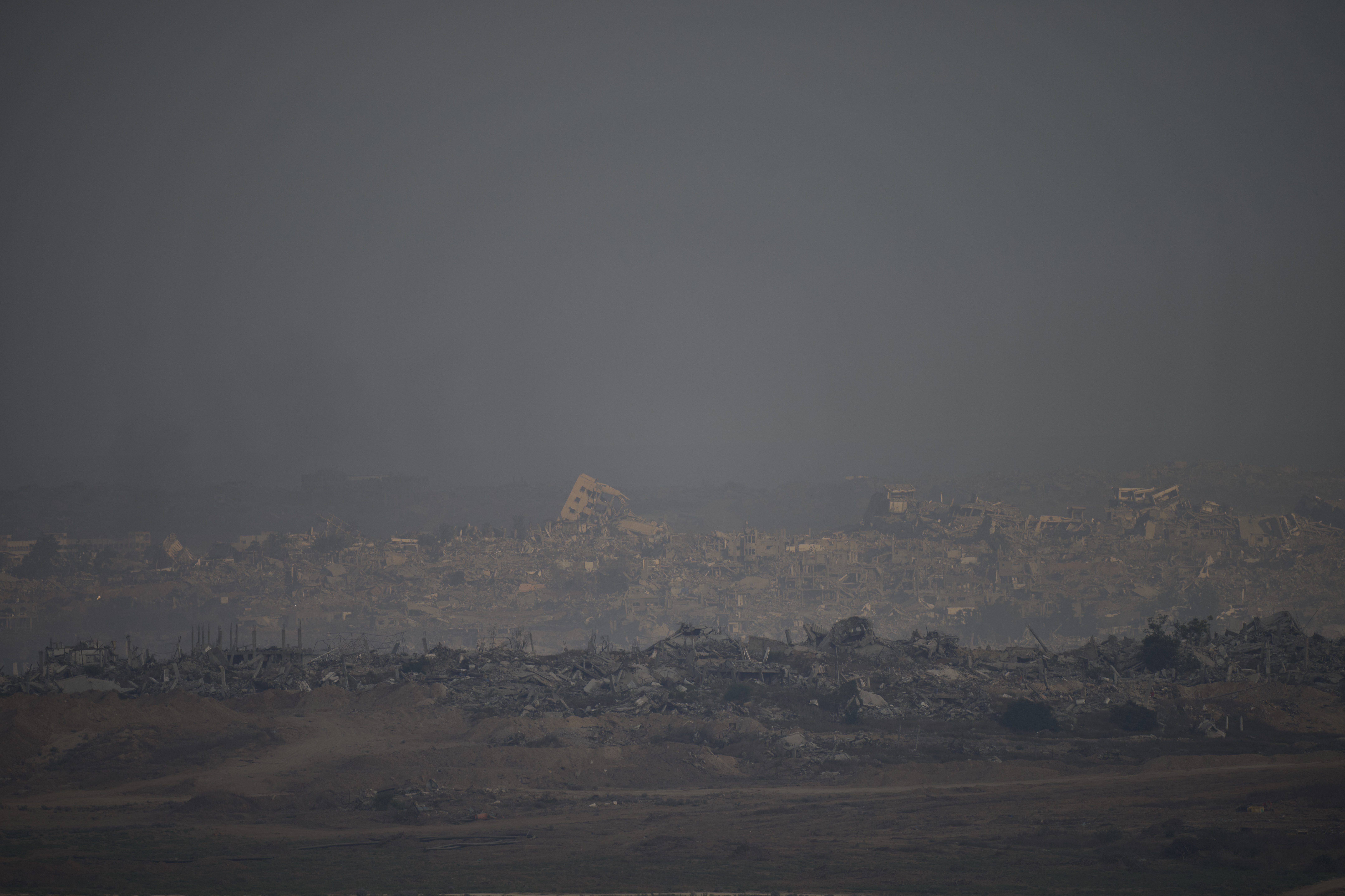 Destroyed buildings in the Gaza Strip are seen from a southern Israel location on Sunday, July 13, 2025. (AP Photo/Ohad Zwigenberg)
