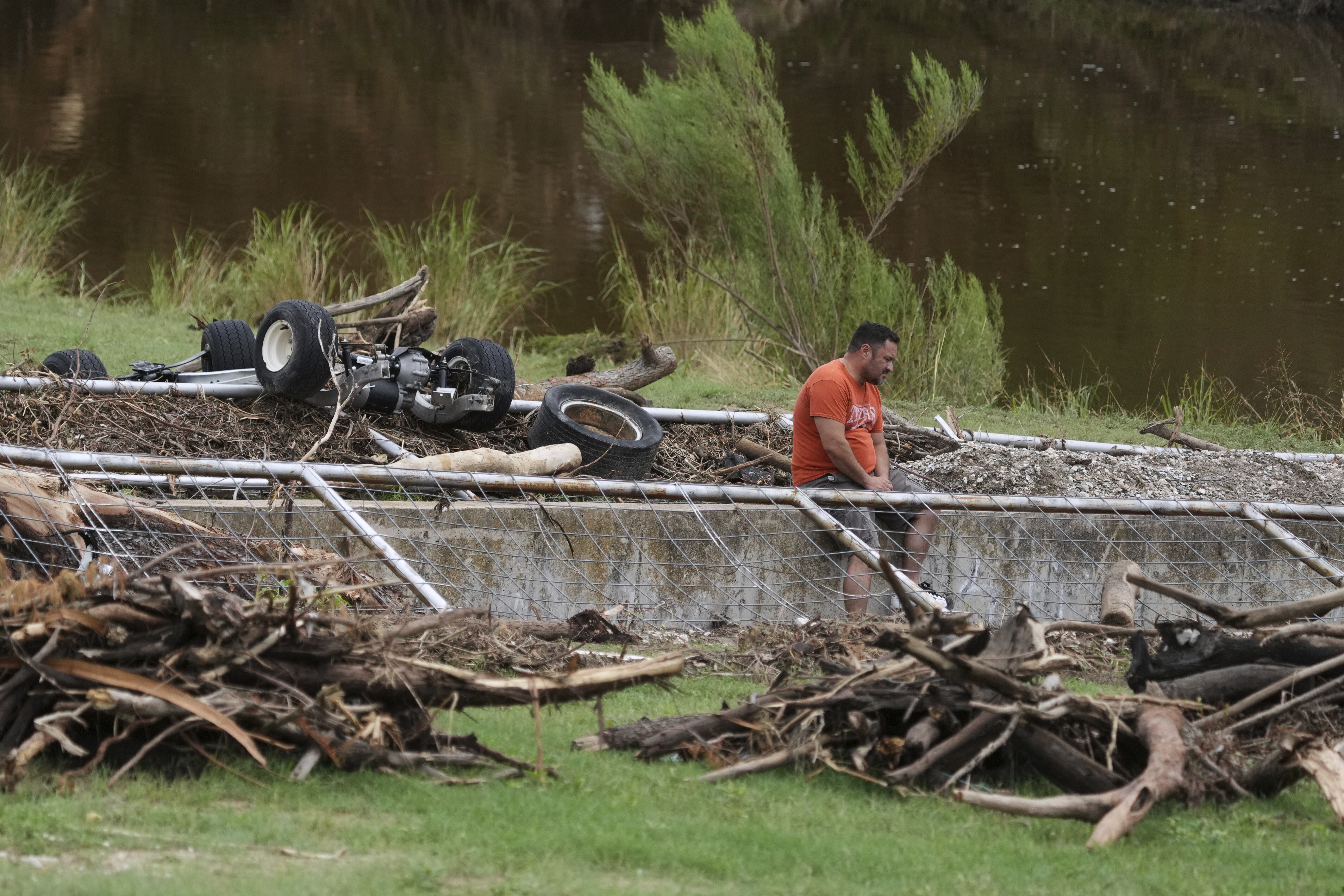 A man surveys debris and flood damage along the Guadalupe River, Sunday, July 13, 2025, in Kerrville, Texas. (AP Photo/Eric Gay)