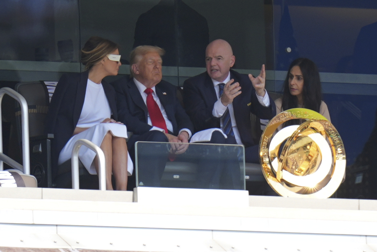 FIFA President Gianni Infantino, right, speaks with President Donald Trump and first lady Melania Trump during the Club World Cup final soccer match between Chelsea and PSG in East Rutherford, N.J., Sunday, July 13, 2025. (AP Photo/Seth Wenig)