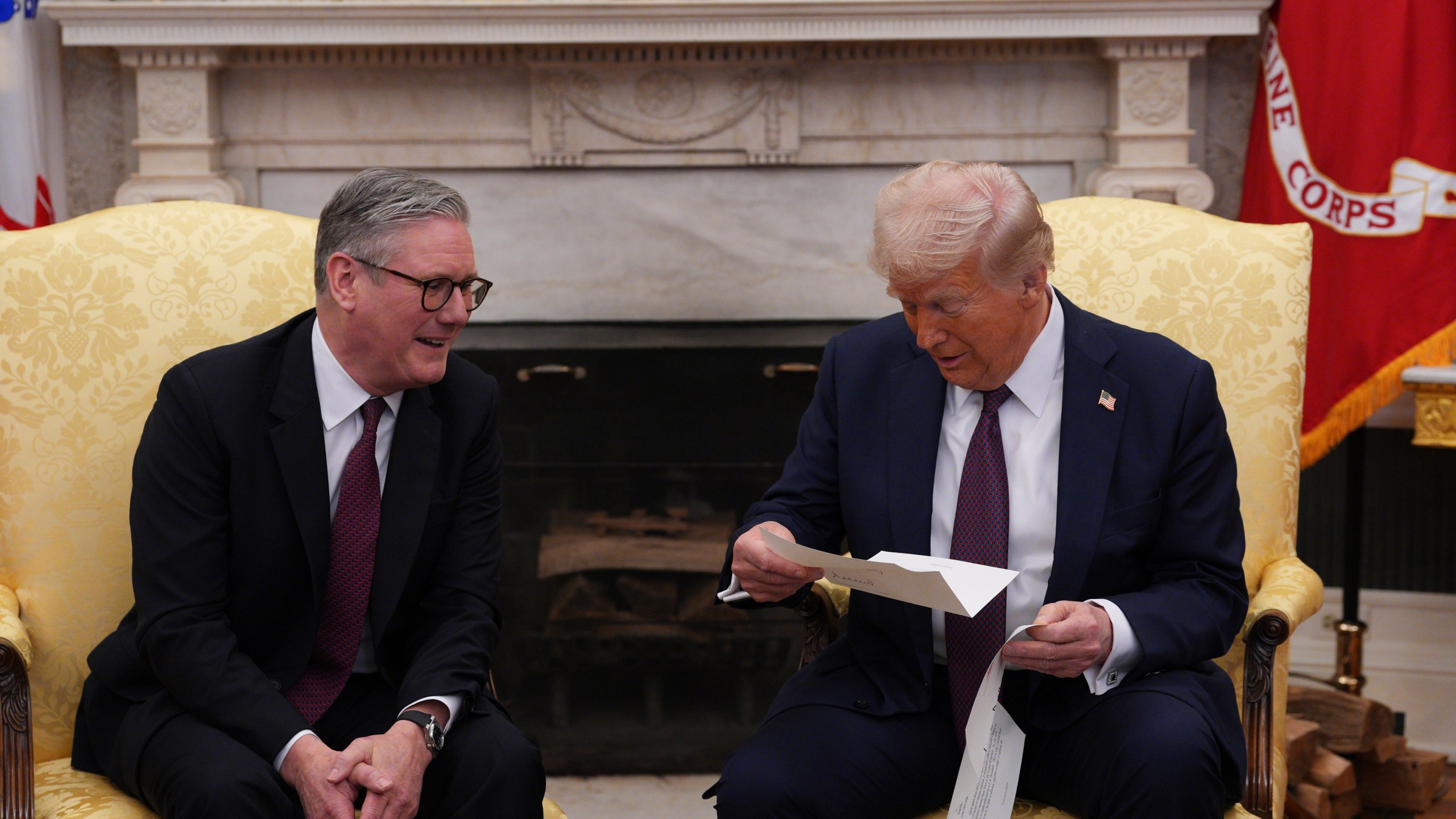 FILE - British Prime Minister Keir Starmer, left, hands an invitation from King Charles III for a second state visit to President Donald Trump at the White House, Thursday, Feb. 27, 2025, in Washington. (Carl Court/Pool via AP, File)