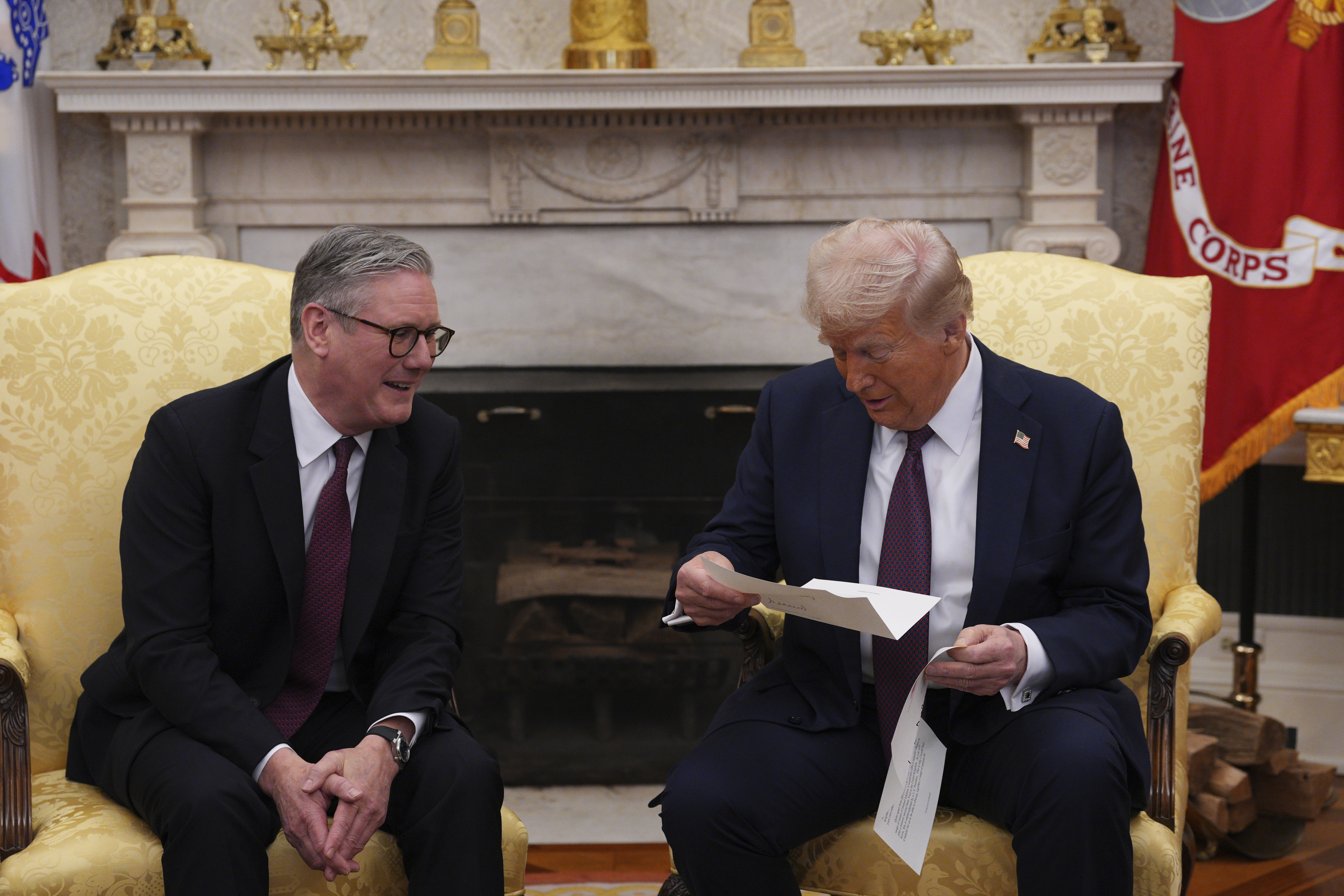 FILE - British Prime Minister Keir Starmer, left, hands an invitation from King Charles III for a second state visit to President Donald Trump at the White House, Thursday, Feb. 27, 2025, in Washington. (Carl Court/Pool via AP, File)