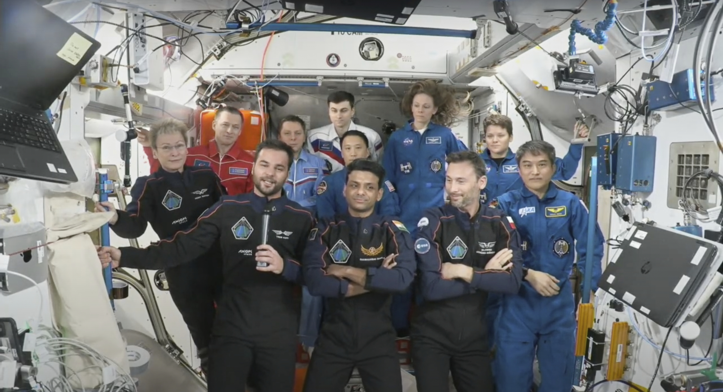 This photo provided by Axiom Space shows the private crew of four, in dark suits, from left, Axiom mission commander Peggy Whitson, Hungary's Tibor Kapu, India's Shubhanshu Shukla and Poland's Slawosz Uznanski-Wisniewski, during a farewell ceremony aboard the International Space Station on Sunday, July 13, 2025. (Axiom Space via AP)