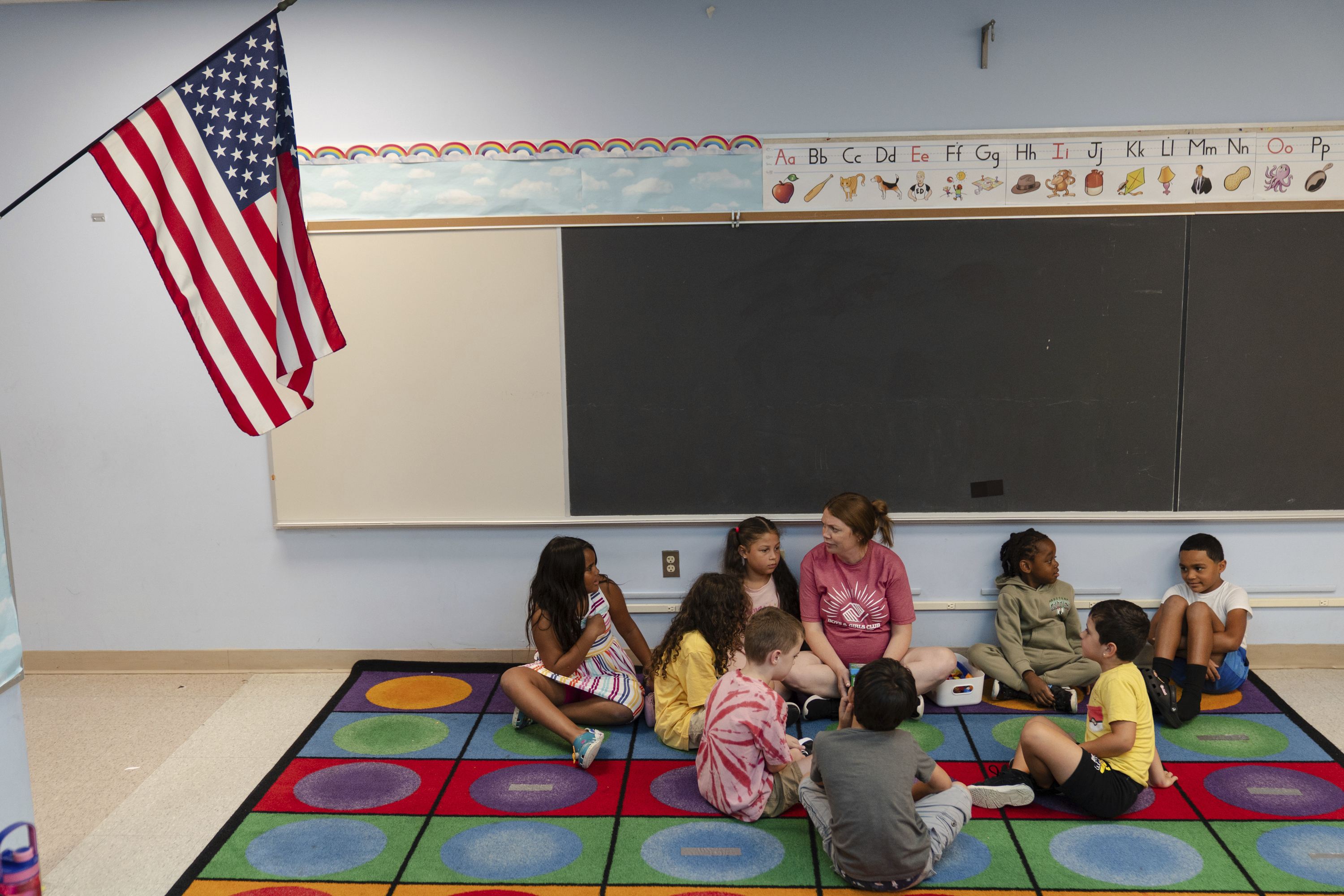 Jillian Murphy leads children in math activities during the East Providence Boys and Girls Club Summer Camp at Emma G. Whiteknact Elementary School on Thursday, July 10, 2025, in Providence R.I. (AP Photo/Sophie Park)