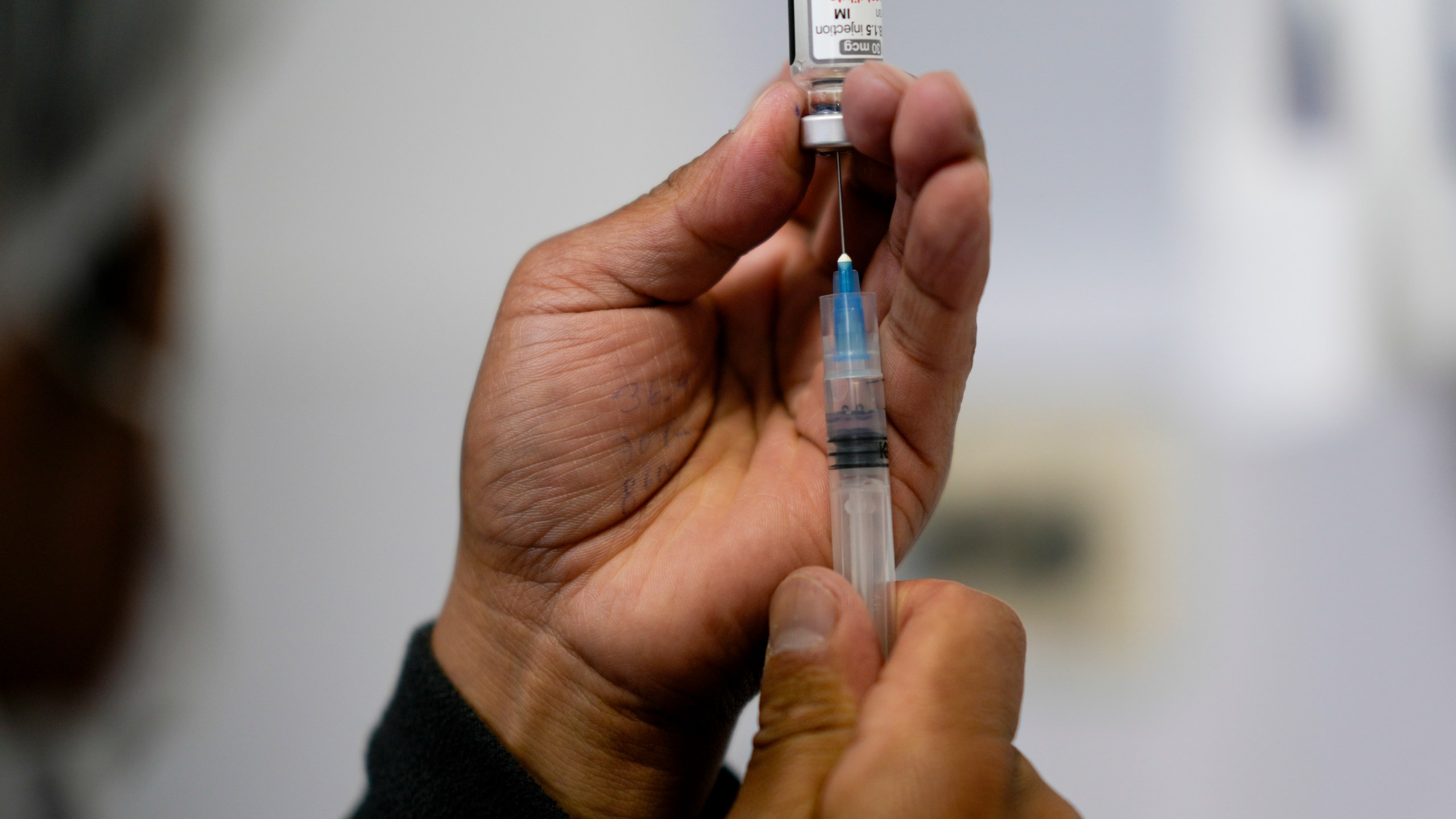 FILE - A healthcare worker prepares a shot of the Pfizer COVID-19 vaccine in La Paz, Bolivia, Jan. 7, 2025. (AP Photo/Juan Karita, File)