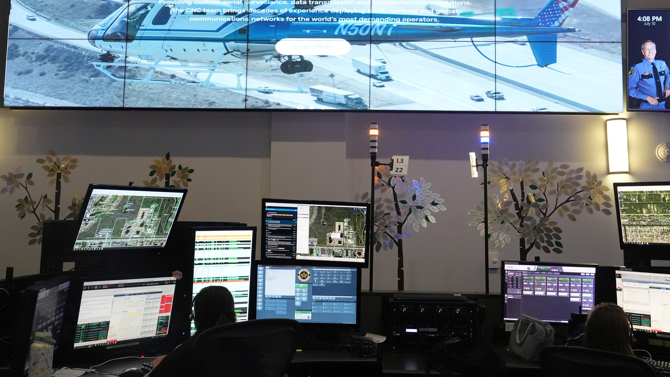 Dispatchers work emergency calls at the Collier County Emergency Services Center, Friday, July 11, 2025, in Naples, Fla. (AP Photo/Marta Lavandier)