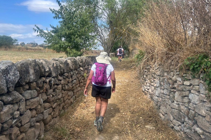 A pilgrim walks along the Ignatian Way heading towards Manresa, Spain, Wednesday, July 9, 2025. (AP Photo/Joseph Wilson)