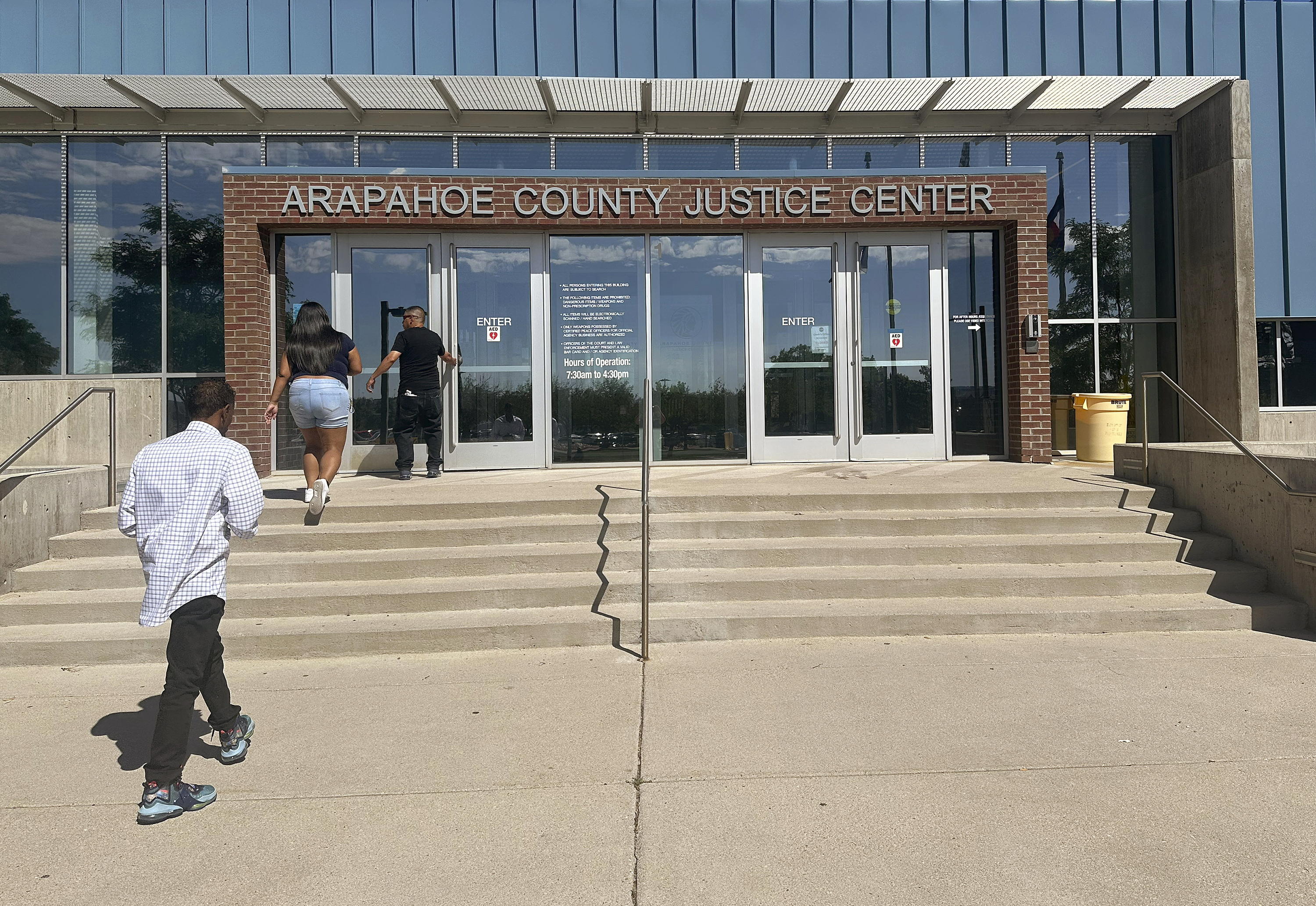 People enter the Arapahoe County Justice Center in Centennial, Colo., on Monday, July 14, 2025. (AP Photo/Thomas Peipert)