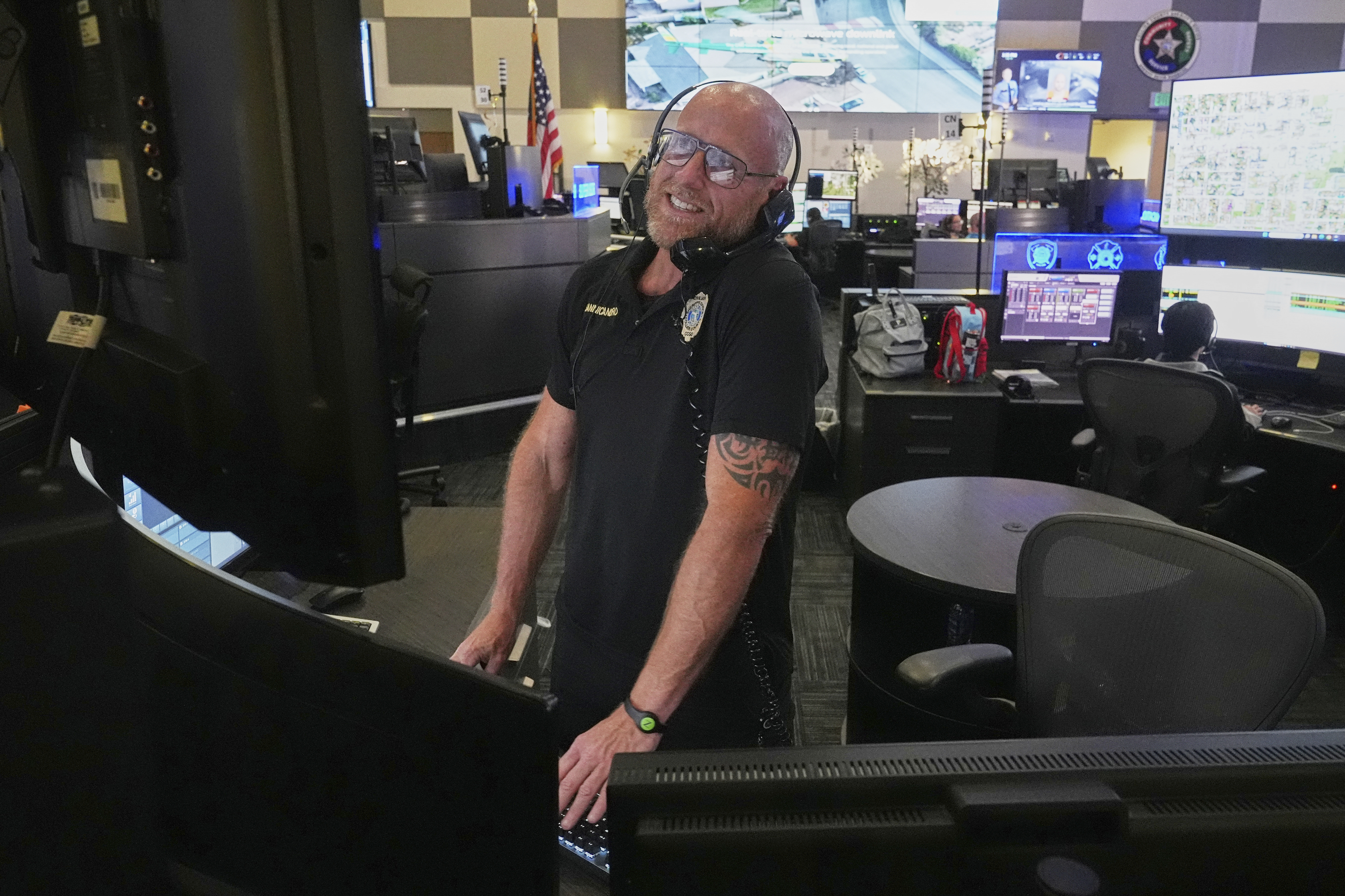 Senior dispatcher Jude Sannicandreo responds to an emergency call at the Collier County Emergency Services Center, Friday, July 11, 2025, in Naples, Fla. (AP Photo/Marta Lavandier)