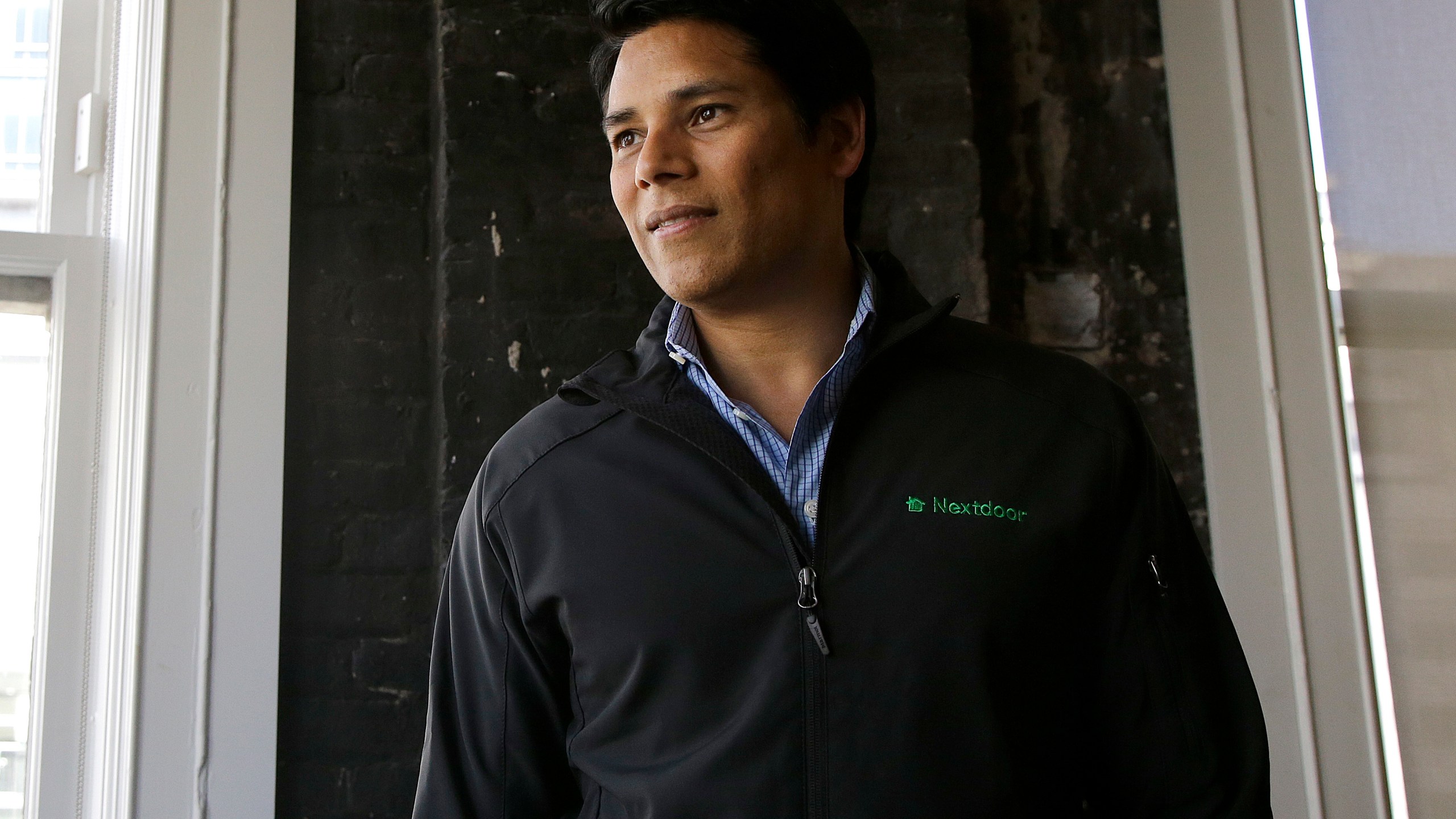FILE - Nextdoor CEO Nirav Tolia poses for photos at his office in San Francisco on May 11, 2016. (AP Photo/Jeff Chiu, File)