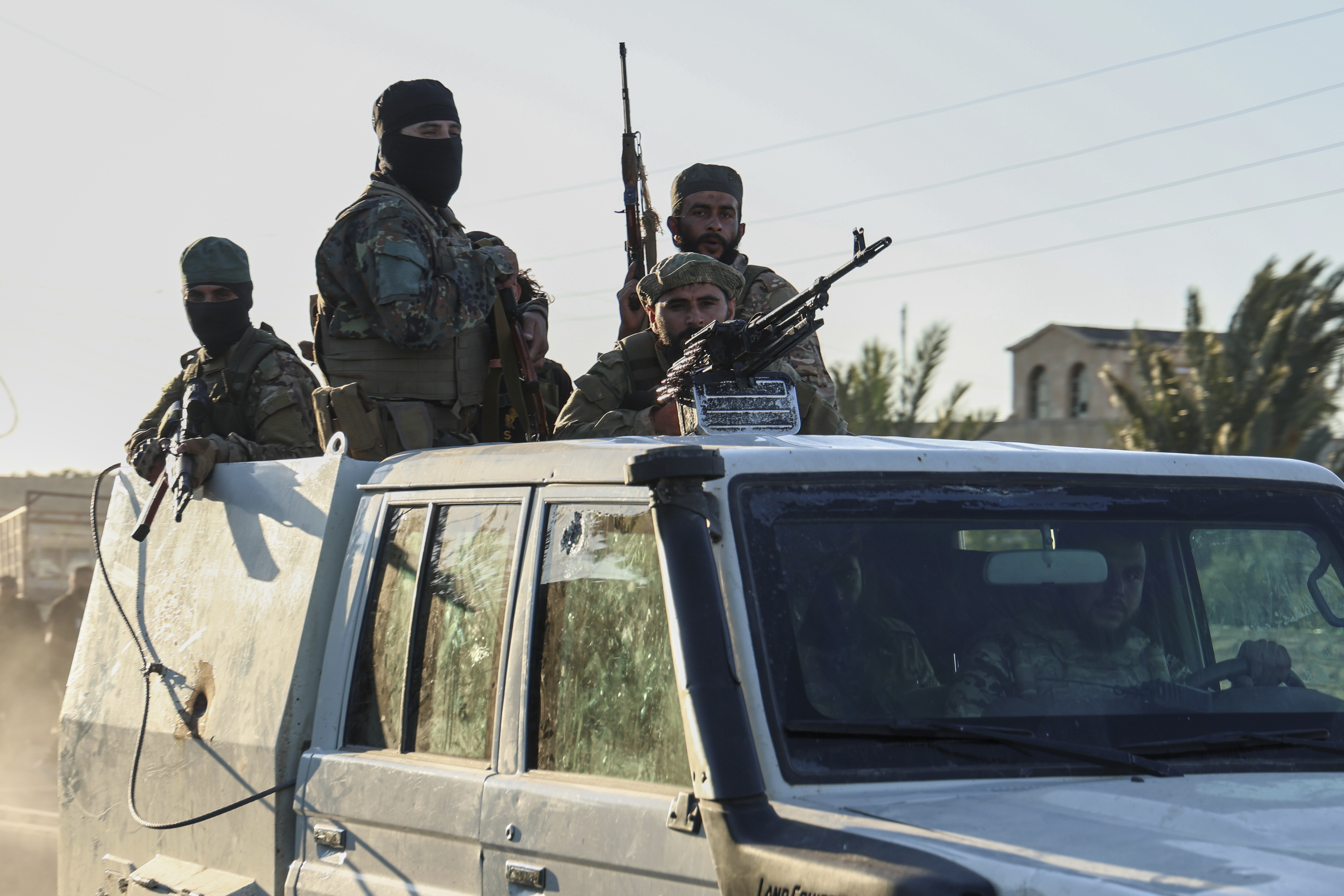 Syrian government forces deploy at the Mazraa village on the outskirts of city of Sweida, where clashes erupted between Sunni Bedouin clans and Druze militias, southern Syria, Monday, July 14, 2025. (AP Photo/Ghaith Alsayed)