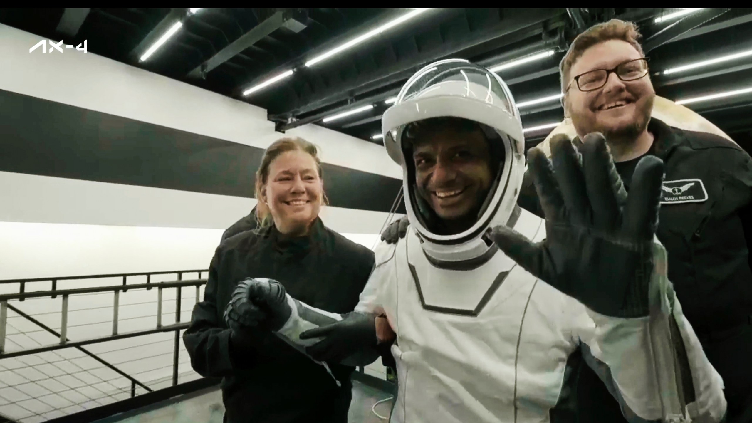 In this image made from video provided by SpaceX, one of the four astronauts, India's Shubhanshu Shukla, waves as he comes out of a SpaceX capsule loaded at the recovery ship after parachuting into the Pacific Ocean off the coast of Southern California on Tuesday, July 15, 2025. (SpaceX via AP)