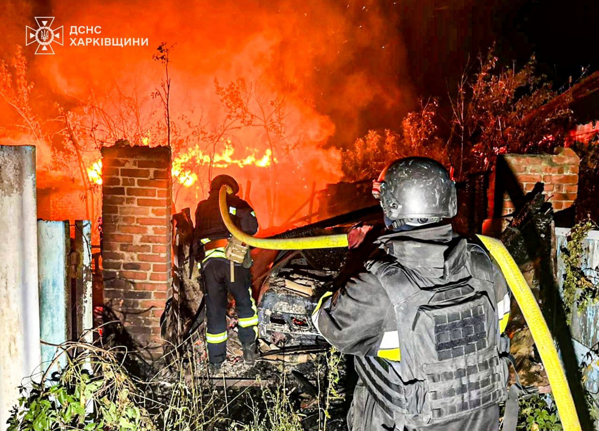 In this photo provided by the Ukrainian Emergency Service, firefighters try to put out a fire following a Russian attack in Kharkiv region, Ukraine, Tuesday, July 15, 2025. (Ukrainian Emergency Service via AP)