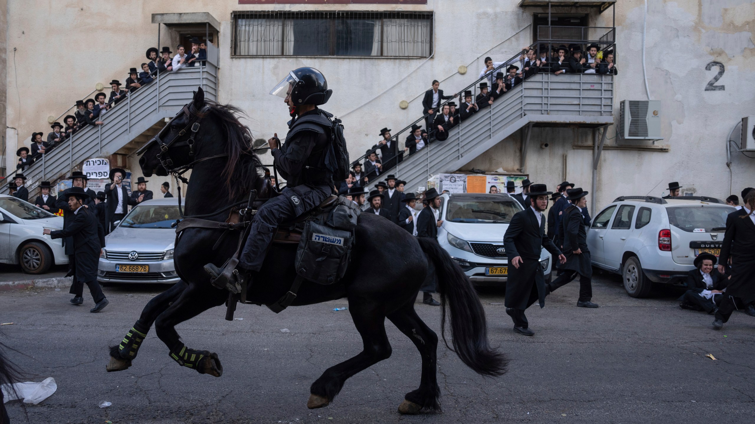 FILE - Israeli police officers scuffle with ultra-Orthodox Jewish men during a protest against a potential new draft law which could end their exemptions from military service in Jerusalem, Thursday, Oct. 31, 2024. (AP Photo/Ohad Zwigenberg, File)