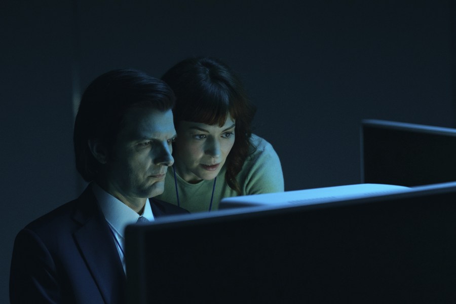 This image released by Apple TV+. shows Adam Scott, left, and Britt Lower in a scene from "Severance." (Apple TV+ via AP)