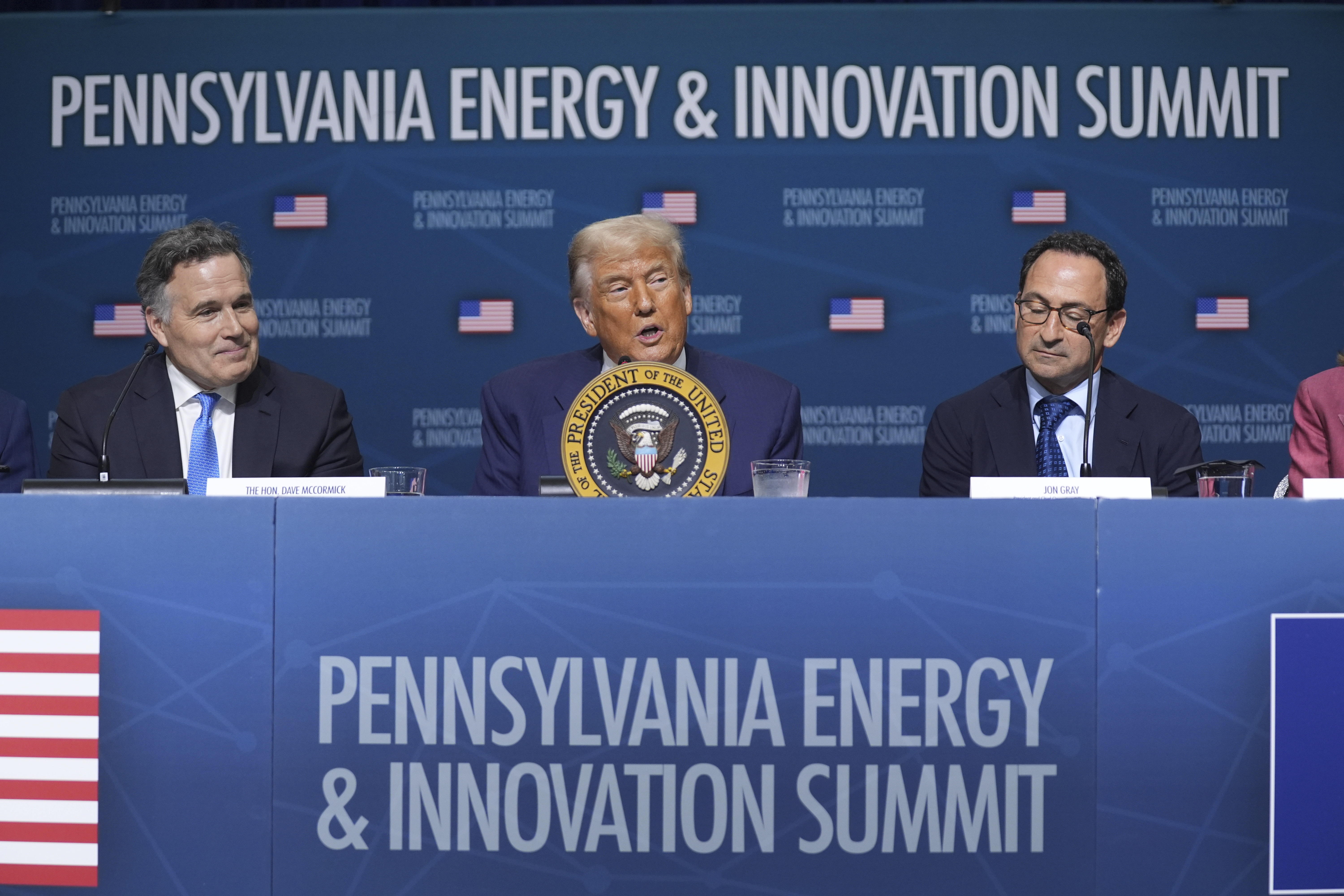 President Donald Trump speaks at the "Inaugural Pennsylvania Energy and Innovation Event" at Carnegie Mellon University, Tuesday, July 15, 2025, in Pittsburgh, as Sen Dave McCormick, R-Pa., left, and Jon Gray, President and Chief Operating Officer, Blackstone, right, look on. (AP Photo/Evan Vucci)