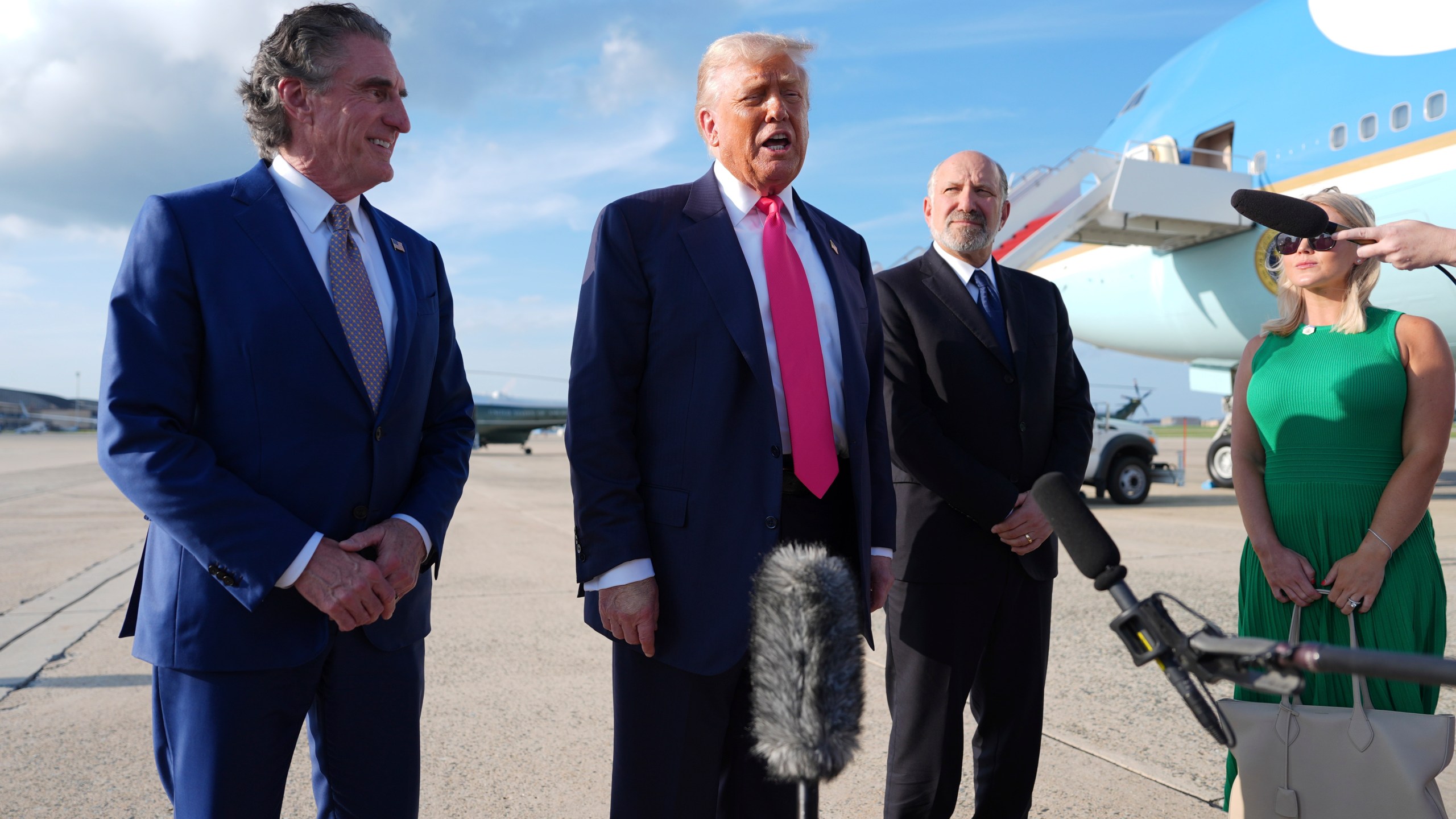 President Donald Trump speaks to the media after arriving at Joint Base Andrews, Tuesday, July 15, 2025, in Joint Base Andrews, Md., as Secretary of the Interior Doug Burgum, left, Secretary of Commerce Howard Lutnick and White House Press Secretary Karoline Leavitt, right, look on. (AP Photo/Evan Vucci)