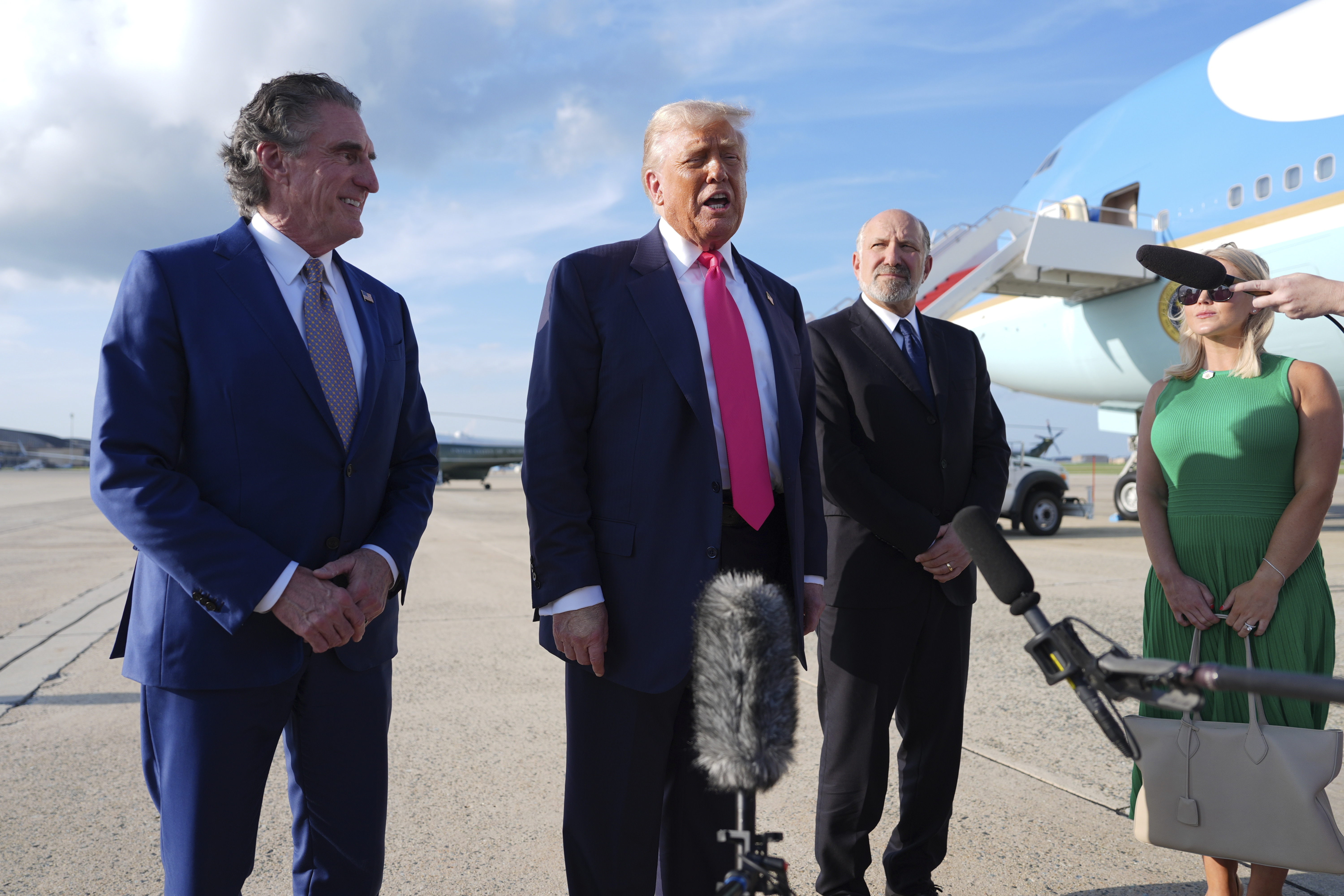 President Donald Trump speaks to the media after arriving at Joint Base Andrews, Tuesday, July 15, 2025, in Joint Base Andrews, Md., as Secretary of the Interior Doug Burgum, left, Secretary of Commerce Howard Lutnick and White House Press Secretary Karoline Leavitt, right, look on. (AP Photo/Evan Vucci)