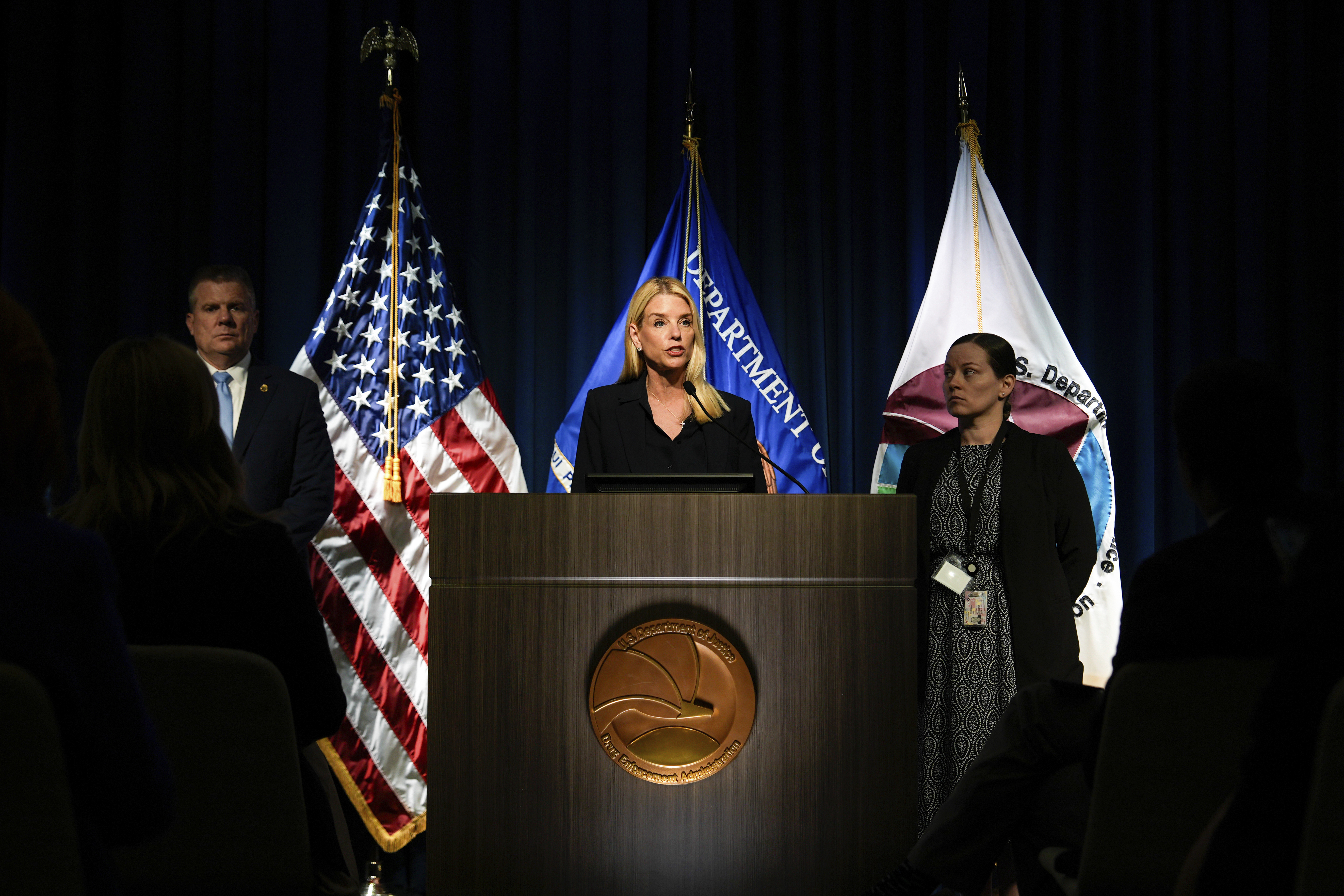 Attorney General Pam Bondi, center, speaks at a news conference at the Drug Enforcement Administration, Tuesday, July 15, 2025, in Arlington, Va. (AP Photo/Julia Demaree Nikhinson)