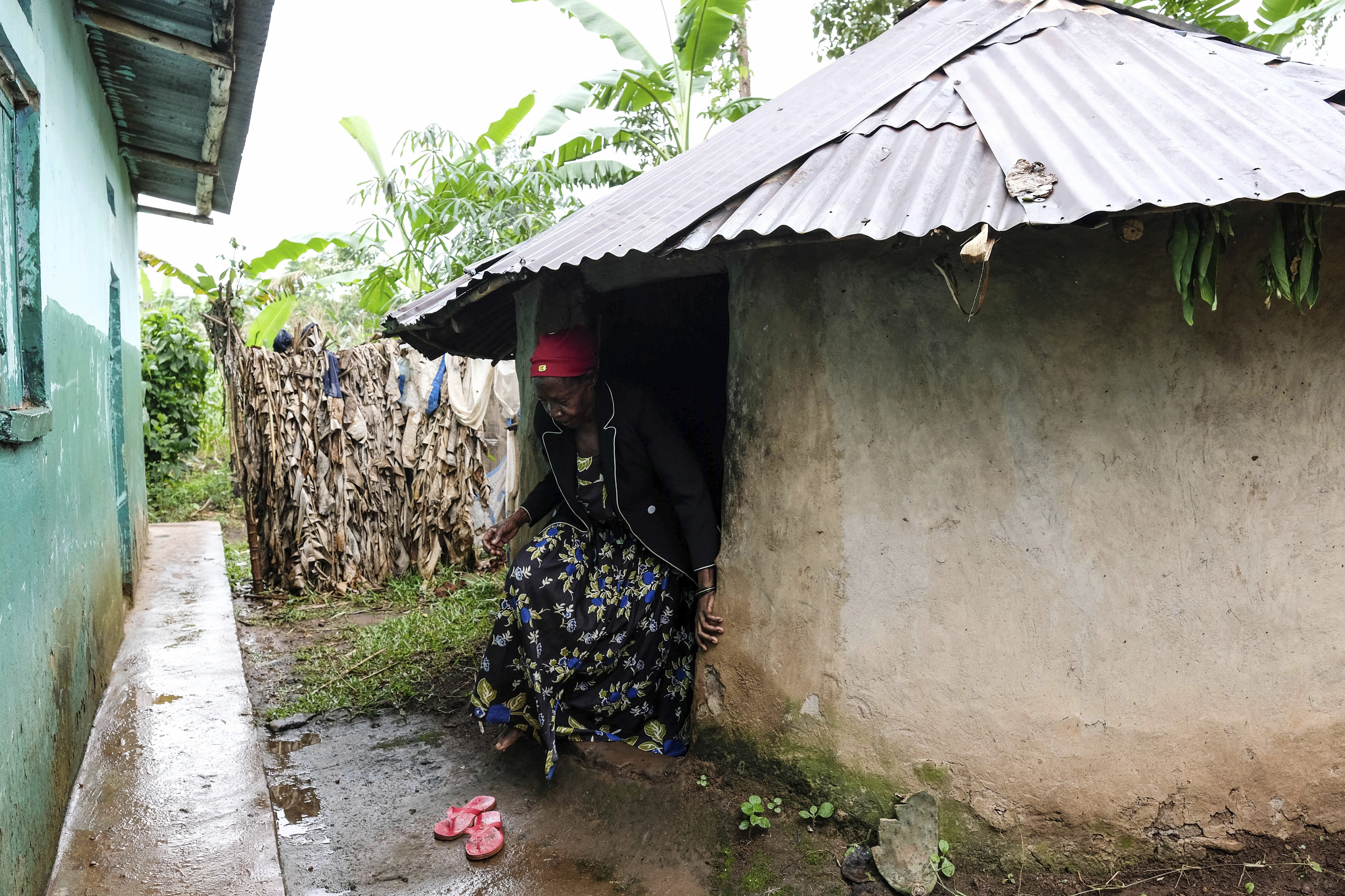 Traditional healer Rose Mukite walks out of her igloo-shaped shrine during an interview with The Associated Press in Kampala, Uganda Monday, June 23, 2025. (AP Photo/Hajarah Nalwadda)