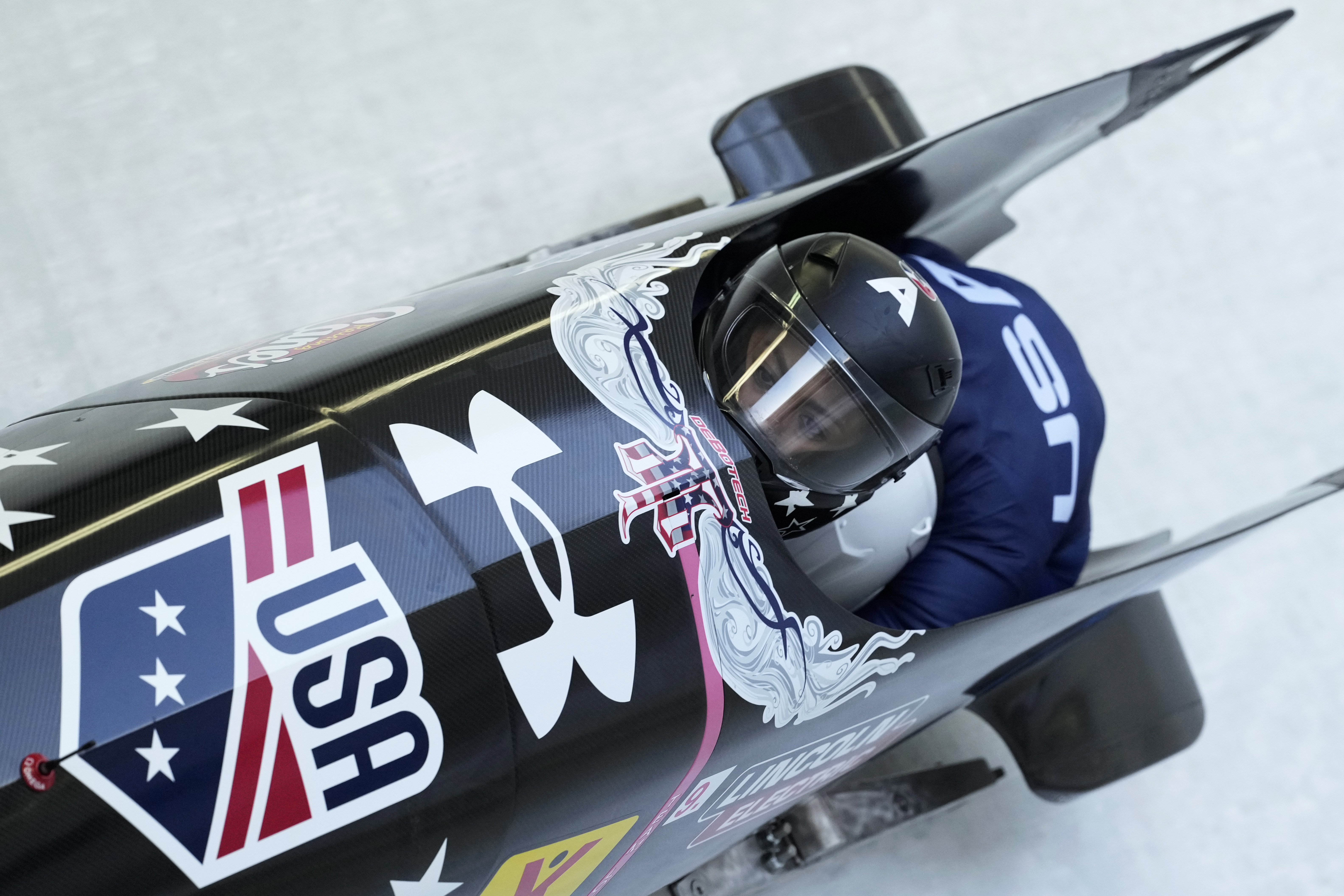 FILE - Kaysha Love and Emily Renna, of the United States, speed down the track during the first run of the 2-woman bobsleigh, at the Bobsleigh World Cup in Innsbruck, Austria, Sunday, Jan. 19, 2025. (AP Photo/Matthias Schrader, File)