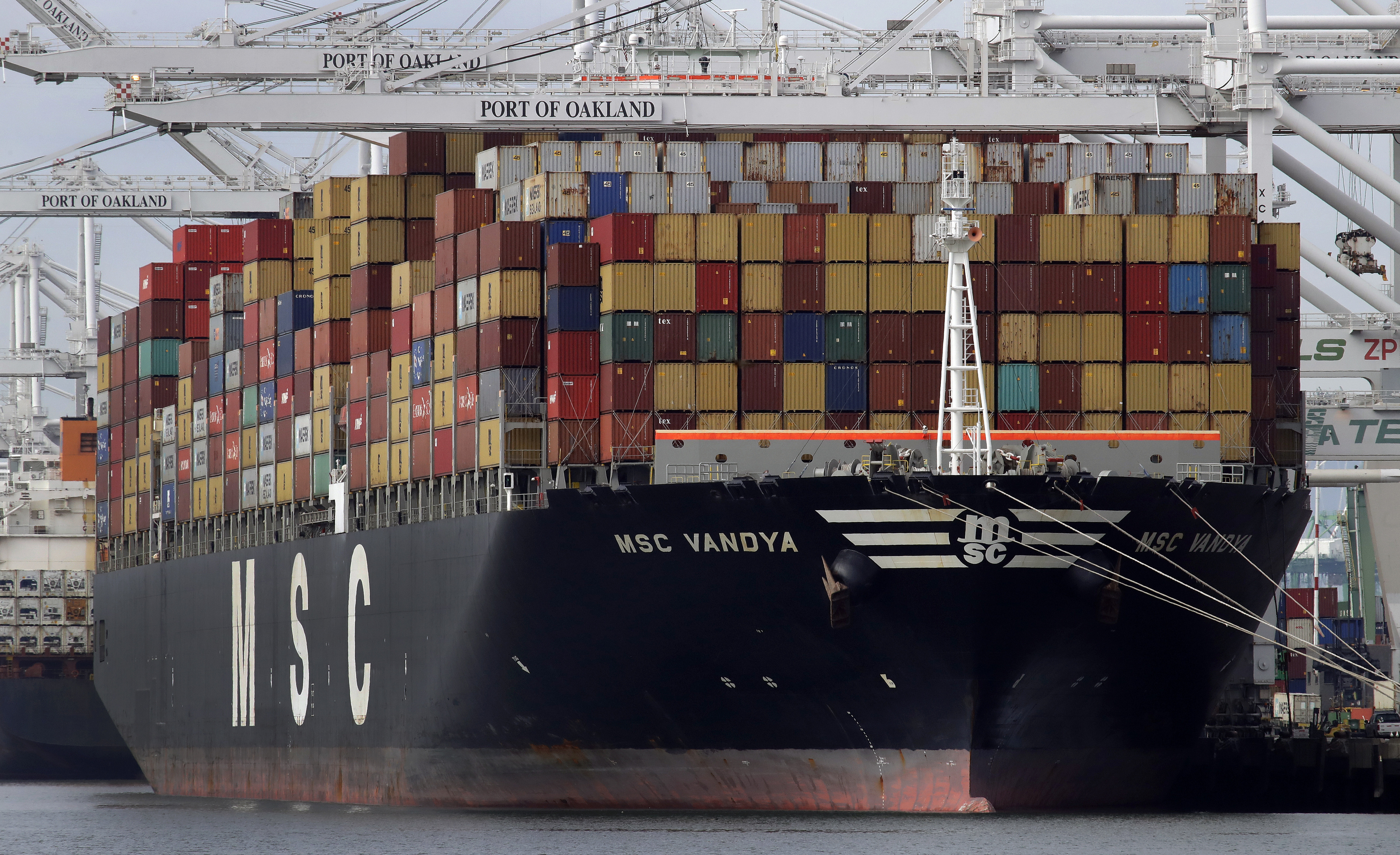 FILE- In this Jan. 28, 2019, file photo a container ship is unloaded at the Port of Oakland in Oakland, Calif. (AP Photo/Ben Margot, File)