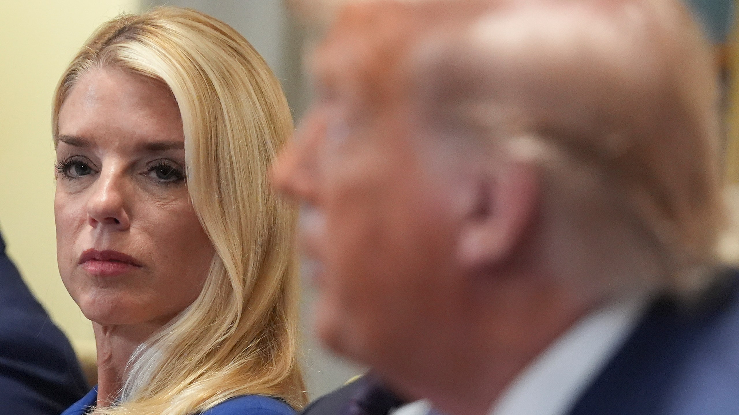 Attorney General Pam Bondi, left, listens as President Donald Trump, right, speaks during a cabinet meeting at the White House, Tuesday, July 8, 2025, in Washington. (AP Photo/Evan Vucci)
