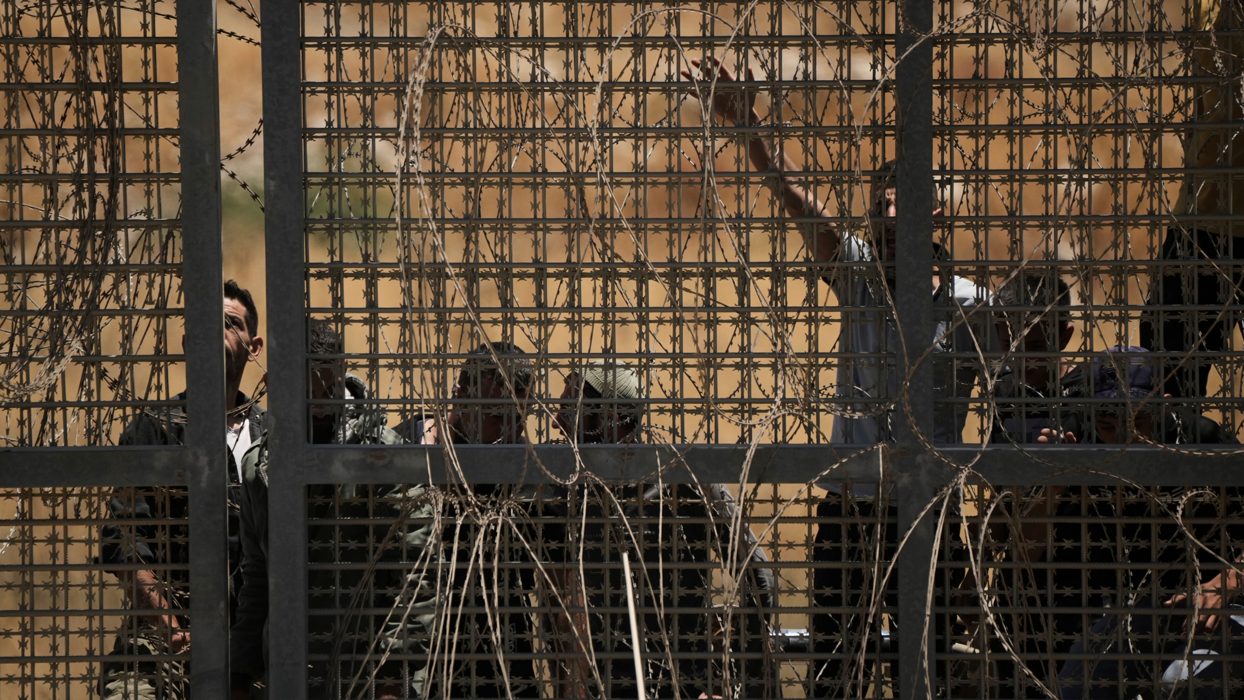Syrian Druze protest near the Israeli-Syrian border, as seen from the town of Majdal Shams in the Israeli-controlled Golan Heights, Wednesday, July 16, 2025, amid the ongoing clashes between Syrian government forces and Druze armed groups in the southern Syrian city of Sweida. (AP Photo/Leo Correa)