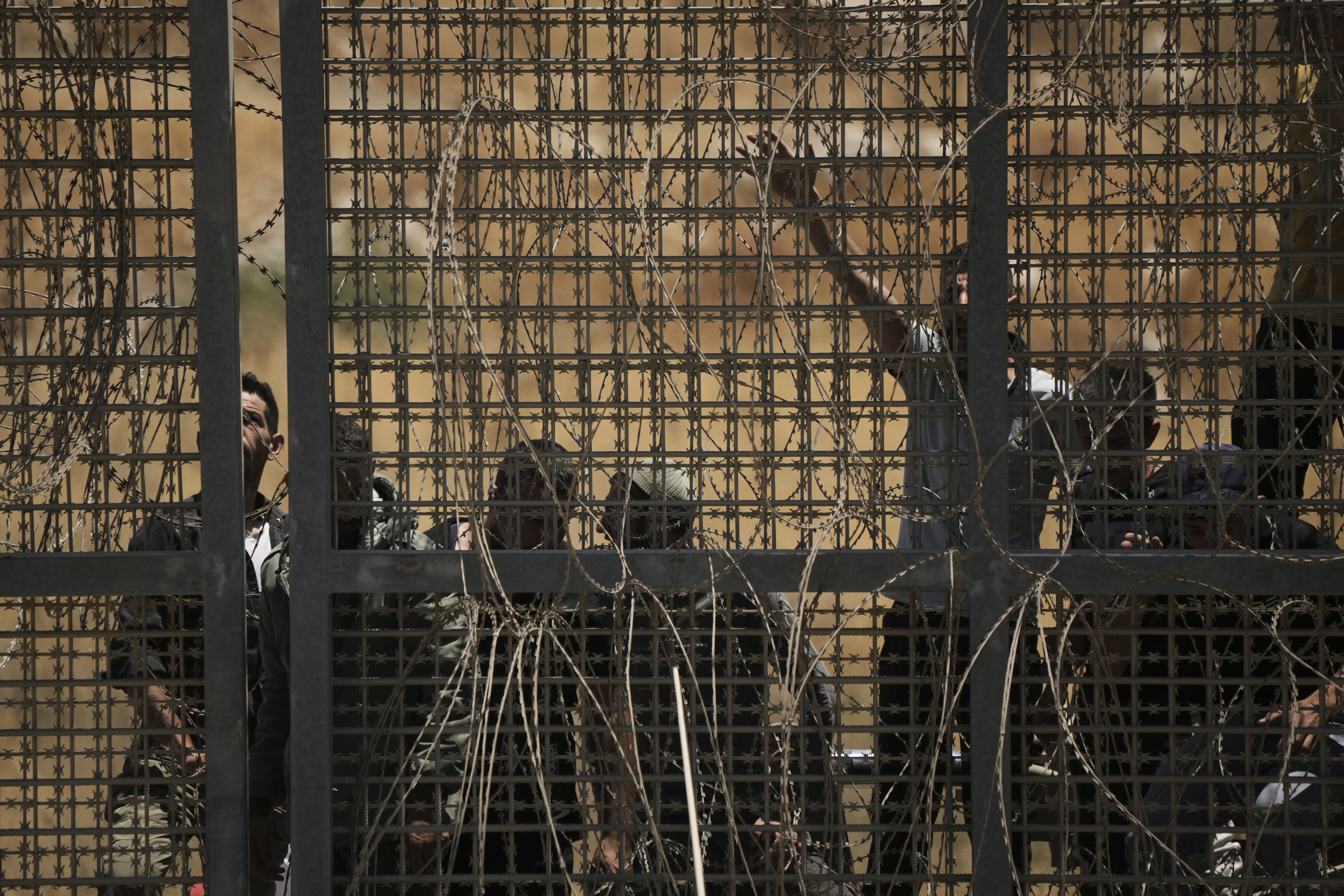 Syrian Druze protest near the Israeli-Syrian border, as seen from the town of Majdal Shams in the Israeli-controlled Golan Heights, Wednesday, July 16, 2025, amid the ongoing clashes between Syrian government forces and Druze armed groups in the southern Syrian city of Sweida. (AP Photo/Leo Correa)