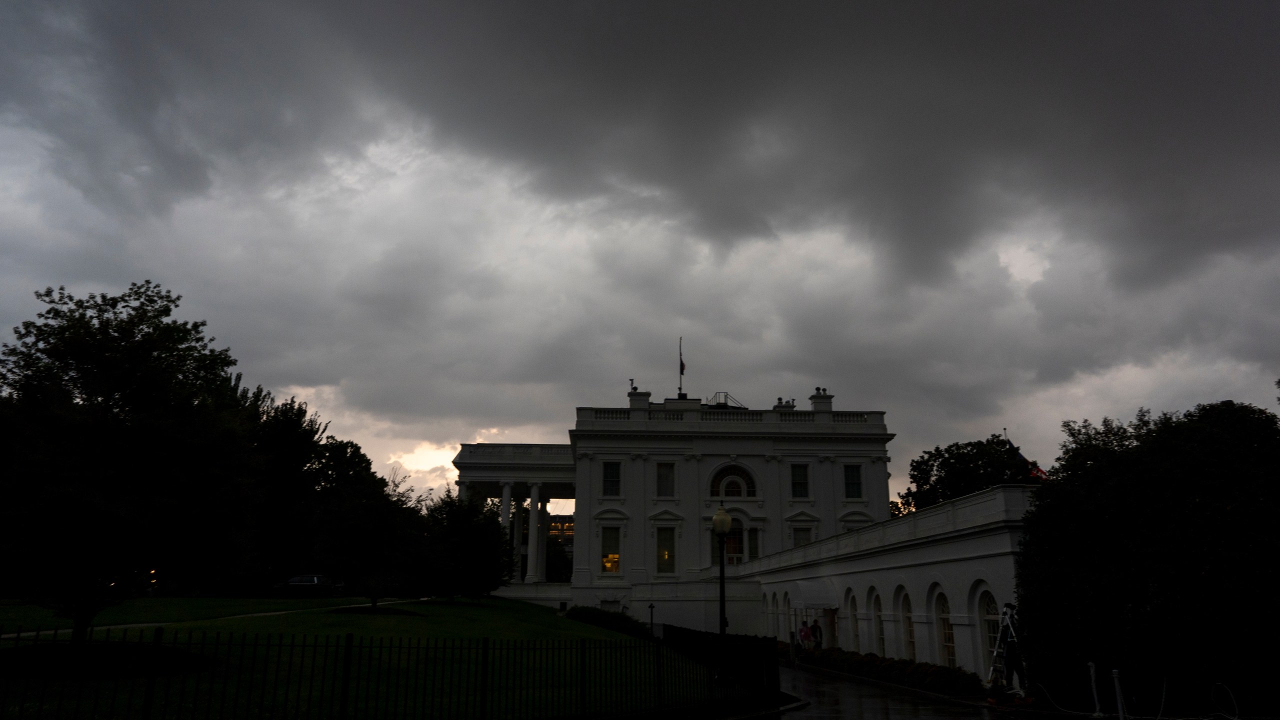Dark clouds hover over the White House as a front of rain moves through, Monday, July 14, 2025, in Washington. (AP Photo/Alex Brandon)