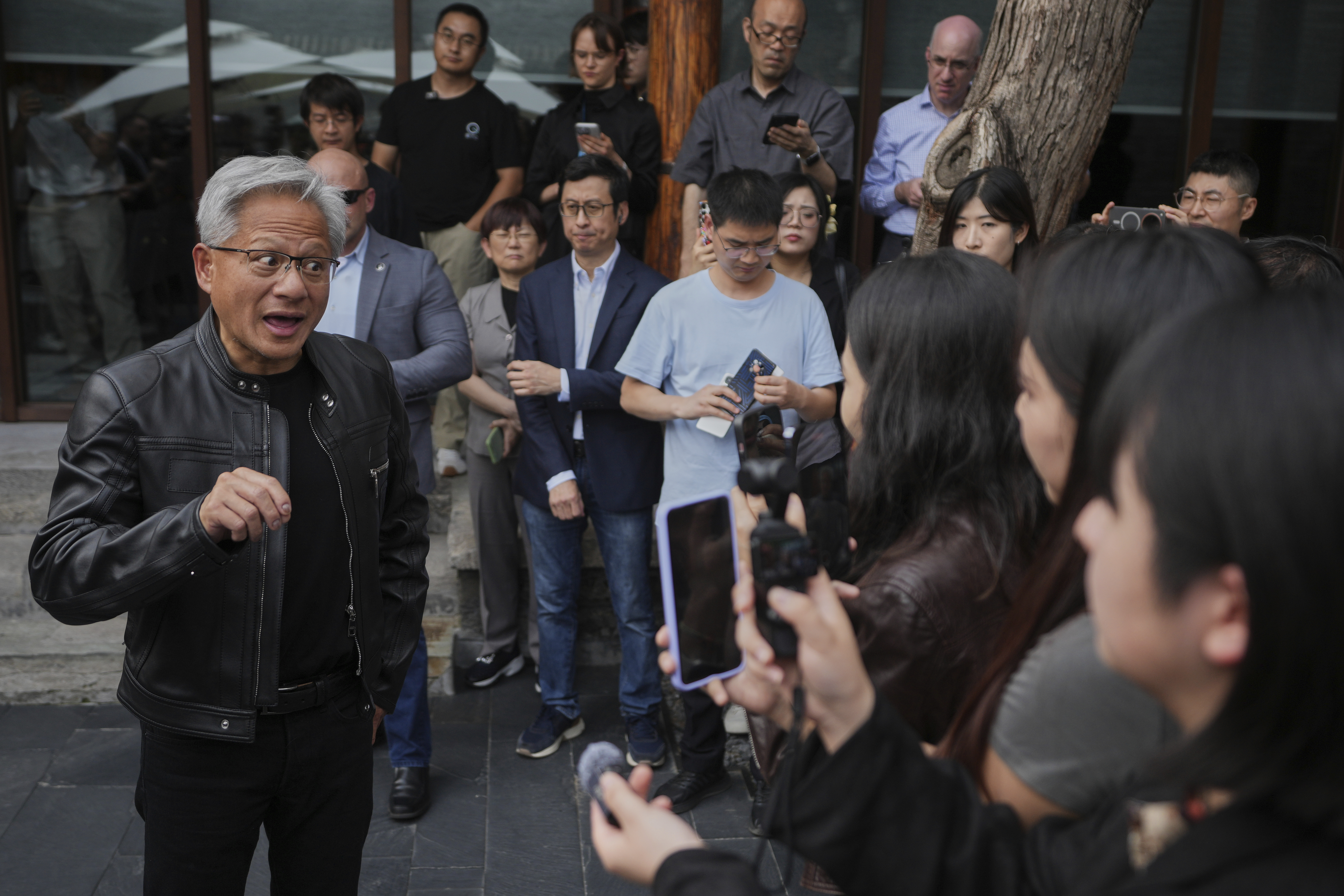 CEO of Nvidia Jensen Huang speaks to journalists during a press conference at the Mandarin Oriental Qianmen after attending the third China International Supply Chain Expo, in Beijing, Wednesday, July 16, 2025. (AP Photo/Andy Wong)
