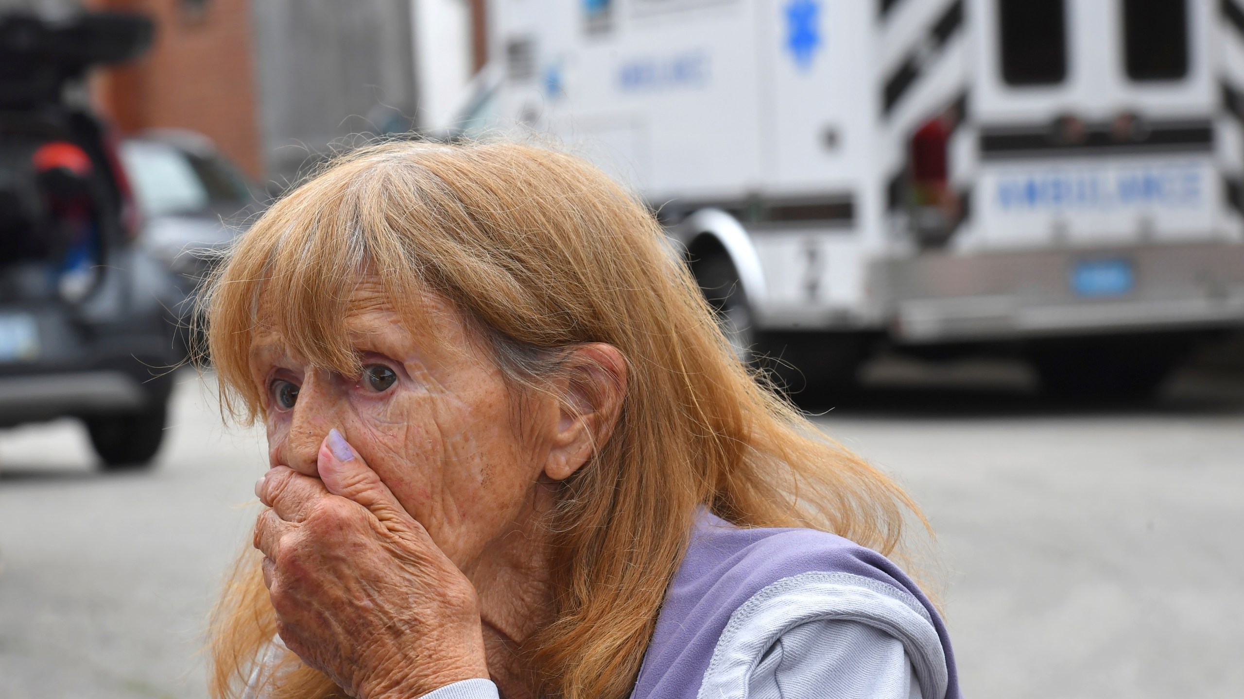Donna Murphy, a resident at the Gabriel House assisted living facility, in Fall River, Mass., speaks with members of the media outside a temporary shelter, Monday, July 14, 2025, in Fall River, Mass., following a fire at the Gabriel House that started late Sunday and resulted in multiple fatalities. (AP Photo/Steven Senne)