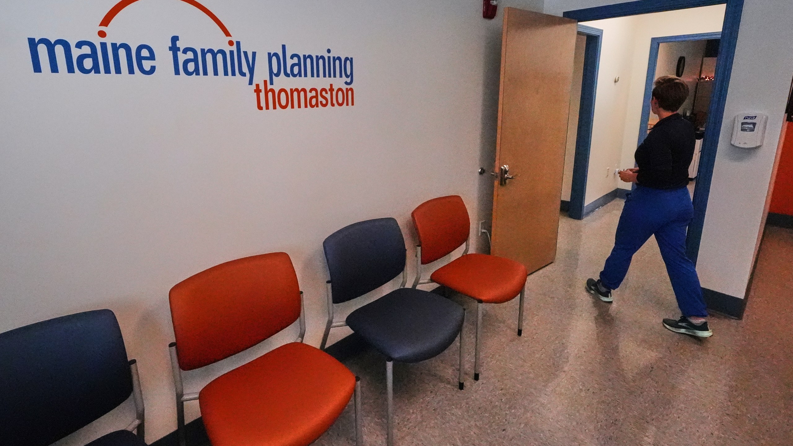 Vanessa Shields-Haas, a nurse practitioner, walks from the lobby toward the examination rooms at the Maine Family Planning healthcare facility, July 15, 2025, in Thomaston, Maine. (AP Photo/Charles Krupa)