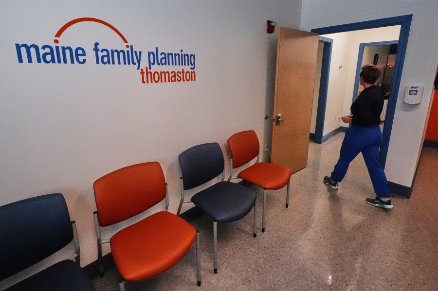 Vanessa Shields-Haas, a nurse practitioner, walks from the lobby toward the examination rooms at the Maine Family Planning healthcare facility, July 15, 2025, in Thomaston, Maine. (AP Photo/Charles Krupa)