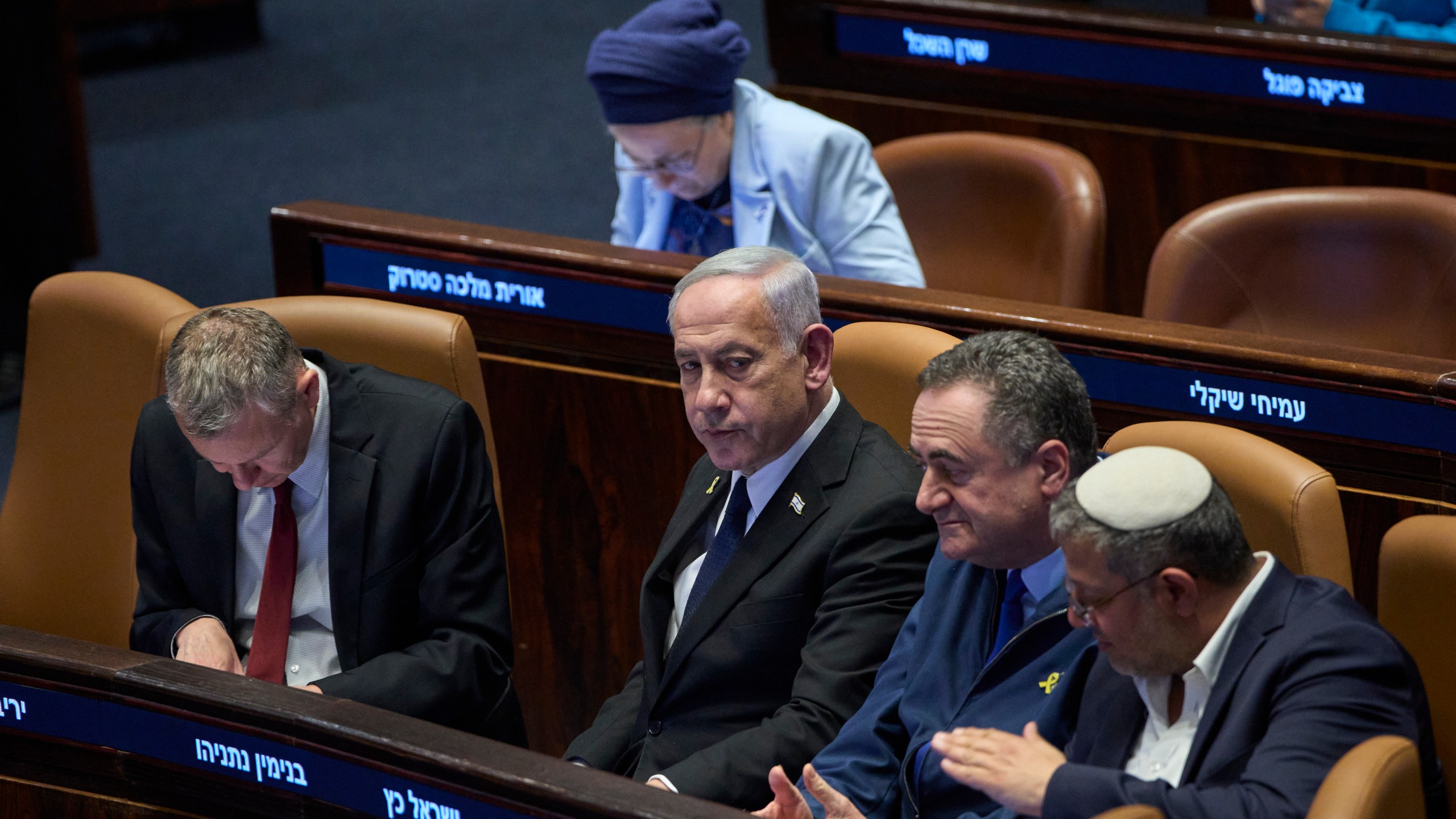 Israel's Prime Minister Benjamin Netanyahu, surrounded by ministers from the government attends a session of the Knesset, Israel's parliament, in Jerusalem, Monday, July 14, 2025. (AP Photo/Ohad Zwigenberg)
