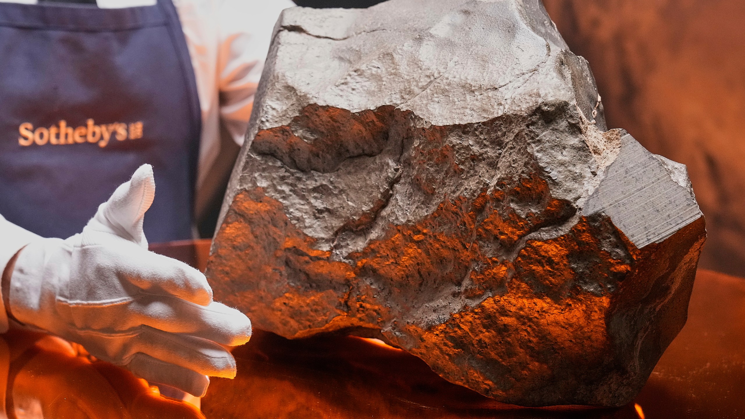 A Martian meteorite, weighing 54.388 lbs. (24.67 kg), said to be the largest piece of Mars on Earth, estimated at $2 - 4 million, is displayed at Sotheby's, in New York, Wednesday, July 9, 2025, part of their Geek Week auction, July 16, 2025. (AP Photo/Richard Drew)