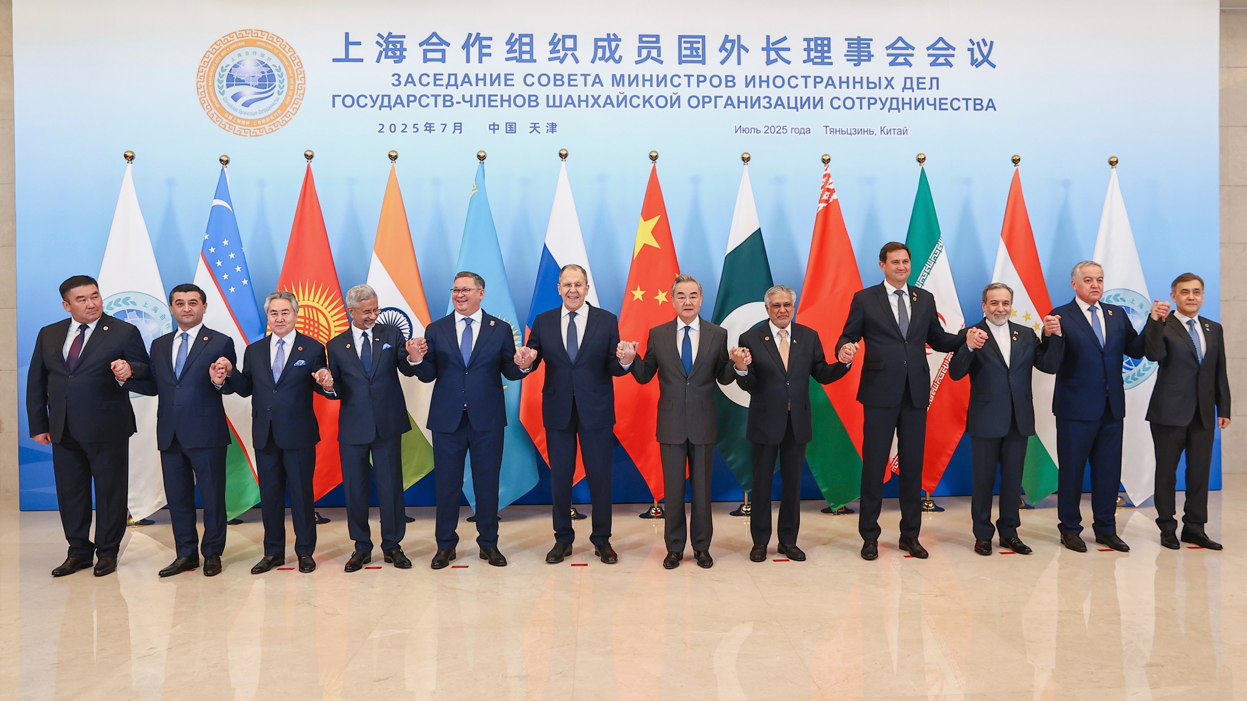 In this photo released by Russian Foreign Ministry Press Service on Tuesday, July 15, 2025, Russian Foreign Minister Sergey Lavrov, center left, and Chinese Foreign Minister Wang Yi, center right, pose for a photo with other officials during the meeting on the Council of Foreign Ministers of the Shanghai Cooperation Organization (SCO), in Tianjin, China. (Russian Foreign Ministry Press Service via AP)