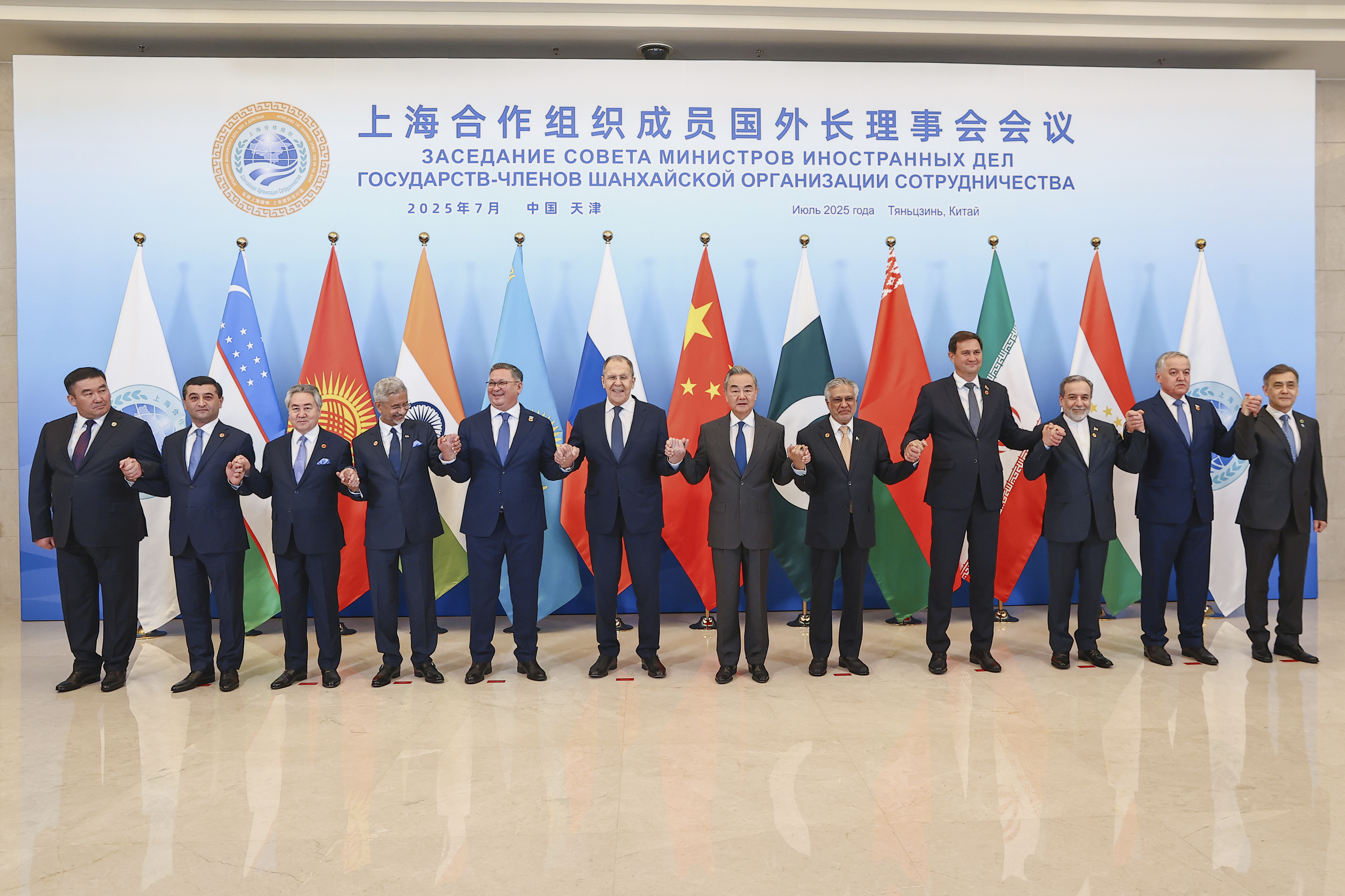 In this photo released by Russian Foreign Ministry Press Service on Tuesday, July 15, 2025, Russian Foreign Minister Sergey Lavrov, center left, and Chinese Foreign Minister Wang Yi, center right, pose for a photo with other officials during the meeting on the Council of Foreign Ministers of the Shanghai Cooperation Organization (SCO), in Tianjin, China. (Russian Foreign Ministry Press Service via AP)