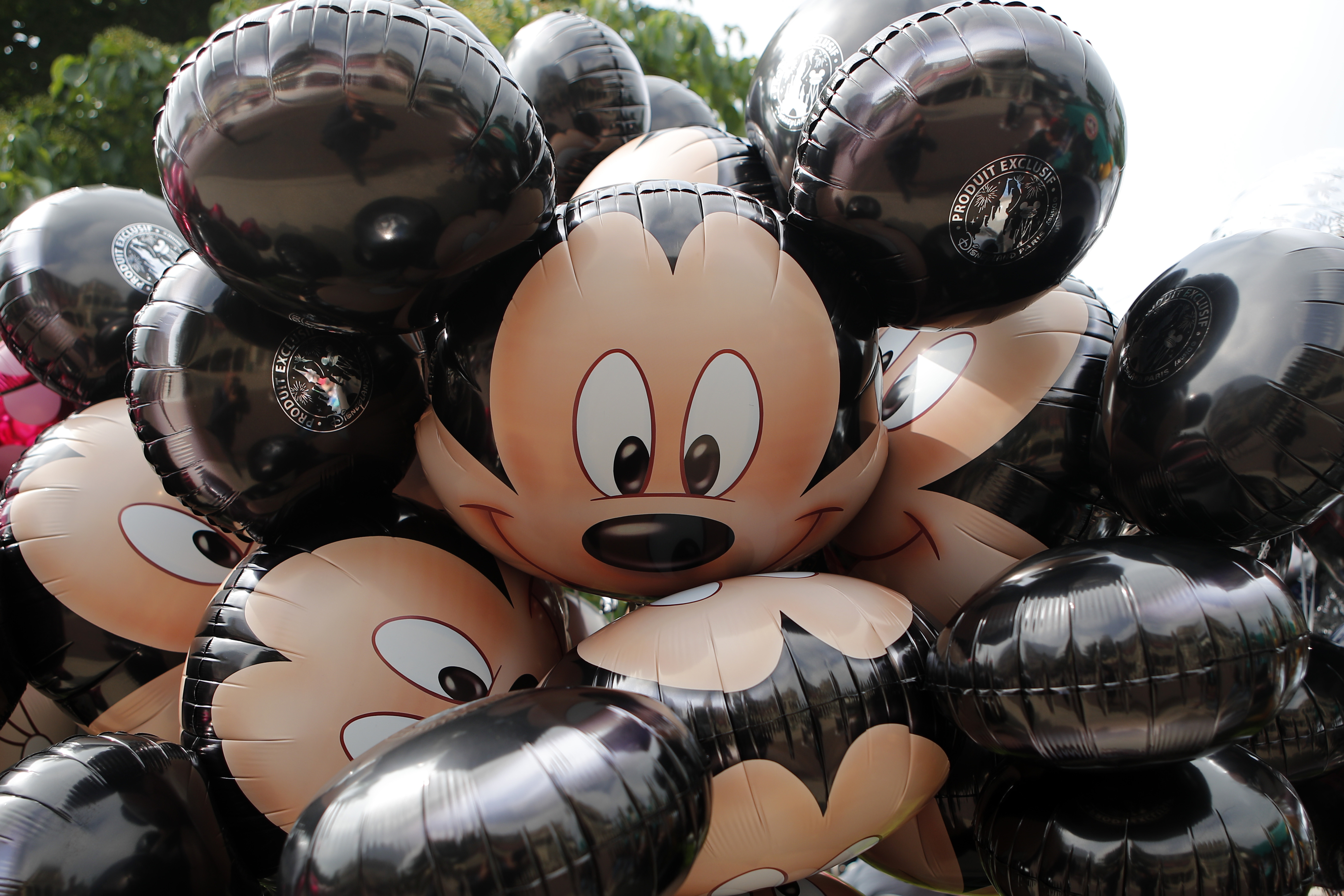 FILE - Mickey Mouse balloons are displayed at Disneyland Paris in Chessy, France, June 8, 2018. (AP Photo/Francois Mori, File)